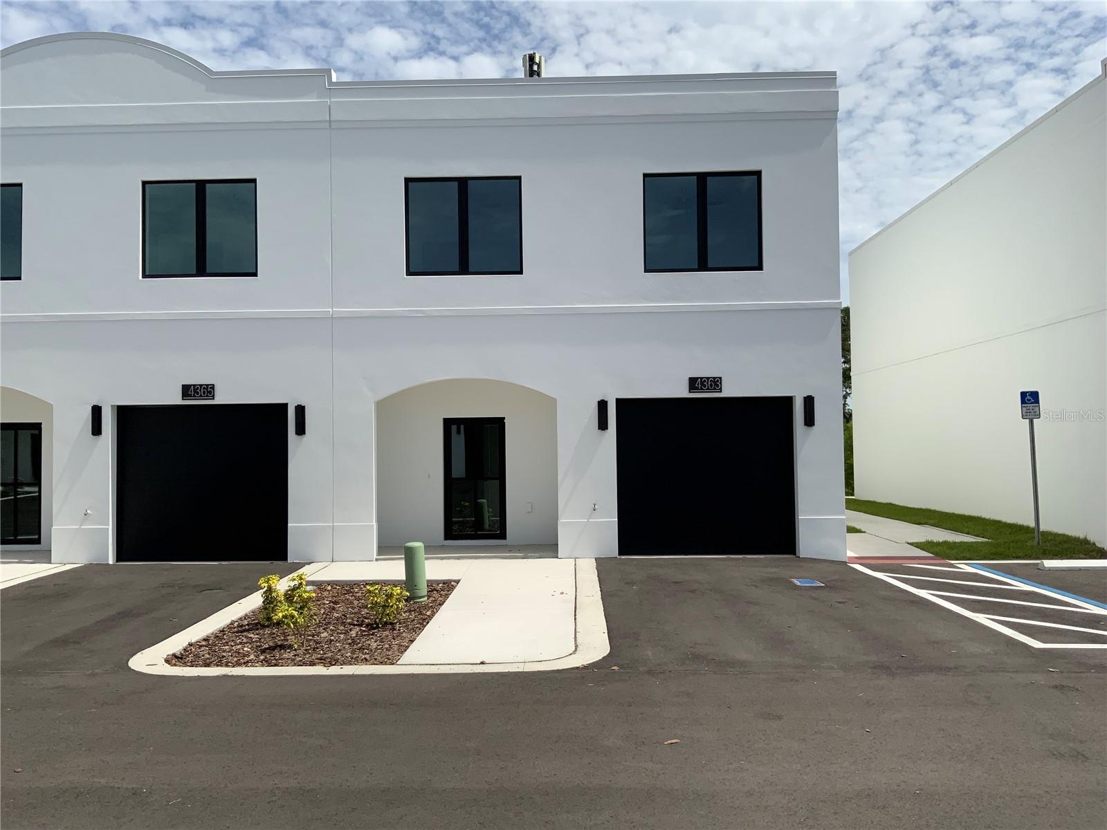 Affordably priced and thoughtfully designed, this brand new two-story townhome offers 3 bedrooms, 2.5 baths, and a 1-car garage with modern finishes throughout. Hurricane-impact glass entry doors welcome you into a bright, open-concept living and dining area filled with natural light. The designer kitchen features granite countertops, modern backsplash, and recessed lighting, blending luxury style with everyday functionality. Upstairs you'll find three spacious bedrooms and contemporary finishes. A dedicated workspace with a custom granite desktop adds convenience for remote work or study. The hacienda-inspired exterior delivers timeless curb appeal, while the location provides easy access to Busch Gardens, Moffitt Cancer Center, major medical facilities, dining, and entertainment. Up to $50,000 in down payment assistance for qualified buyers. Don't miss the opportunity to own new construction in Tampa. Photos are of a furnished model and are for illustrative purposes only.
