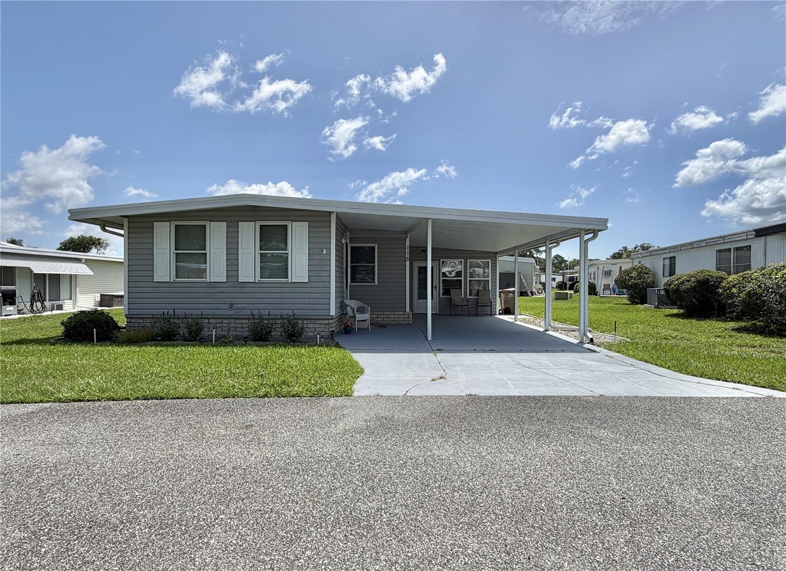Welcome home to effortless Florida living! Beautifully refreshed and offered fully furnished, this spacious 2-bedroom, 2-bath home offers 1,434 sq. ft. of thoughtfully designed living space that’s ready for you to enjoy from day one. Enter through the inviting enclosed Florida room, which opens into a bright and expansive living and dining area, creating a warm and welcoming atmosphere. The beautifully updated kitchen is the heart of the home, featuring contemporary appliances, modern fixtures, gorgeous countertops, stylish lighting, and plenty of cabinet and counter space. Brand-new laminate flooring flows throughout the home, adding a fresh, modern touch. A wonderful bonus is the 11’ x 19’ carpeted enclosed sunroom, located along the side of the home with direct access from the carport. Comfortable and versatile, this space is perfect as a family room, hobby room, home office, or even an extra sleeping area for visiting family and friends. The sunroom connects to the oversized utility/laundry room, complete with abundant storage cabinetry and its own window A/C unit for added comfort. Both generously sized bedrooms feature large walk-in closets. The spacious primary suite includes a walk-in shower, while the guest bath offers a tub and an oversized vanity with plenty of countertop space. Additional upgrades include double-pane windows, a 2019 HVAC system, low-maintenance vinyl siding, and a durable TPO roof-over, providing comfort and peace of mind for years to come. Fully furnished and beautifully updated, this move-in-ready home offers the perfect combination of space, flexibility, and Florida charm. Whether you’re looking for a full-time residence or a seasonal retreat, you’ll appreciate the extra room to entertain, host overnight guests, and enjoy the relaxed lifestyle you’ve been searching for....................Hawthorne at Leesburg is an active, resident owned, 55+ cooperative, waterfront, gated community, with beautifully landscaped grounds, lakes with illuminated fountains and a relaxing and comfortable gazebo. The affordable monthly maintenance fee of $397 includes water, sewer, lawn mowing, private emergency services and storage space for recreational vehicles, boats, trailers and much more! The beautiful clubhouse is complete with a full-time program coordinator, more than 100 different activities and seating for 550. It has a hospitality lounge, card rooms, craft rooms, billiard room, fitness center, library, fine arts room and many more. There is excellent fishing, outdoor geo-thermally heated pool and two enclosed therapeutic pools. Hawthorne boasts a private marina monitored by an electronic security system with over 120 boat slips and access to the Harris Chain of Lakes and beyond.