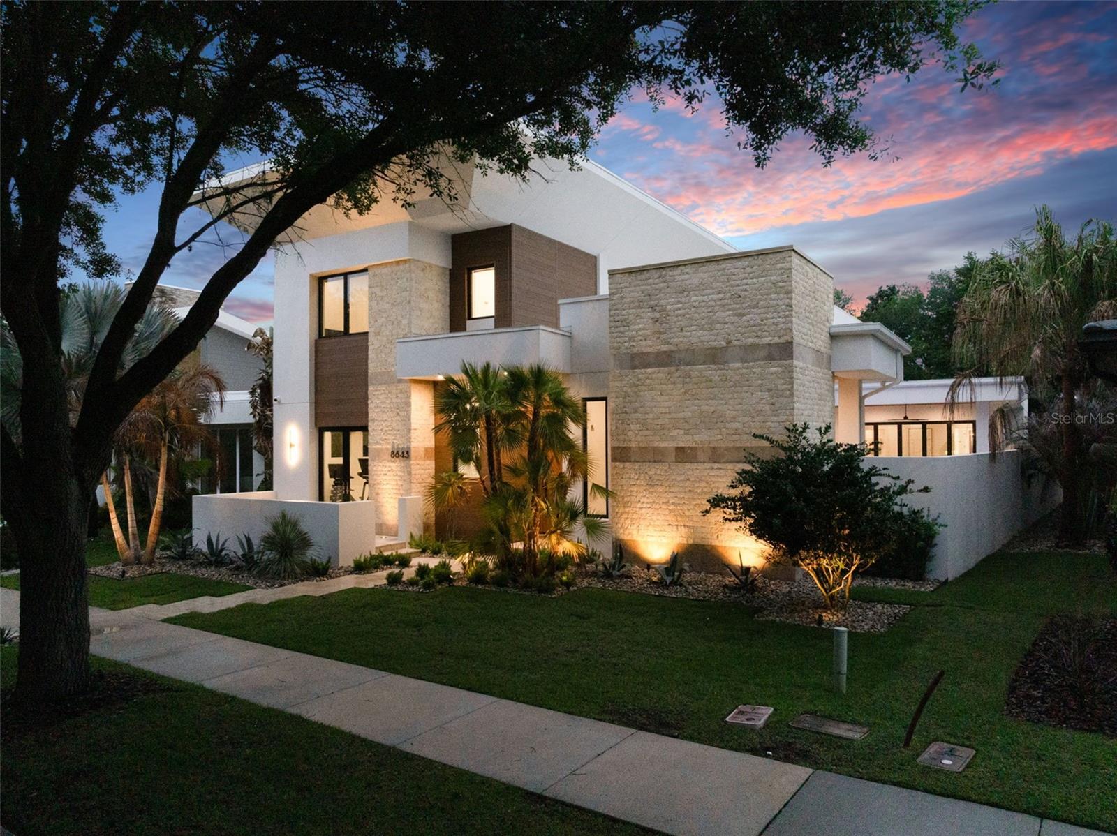Welcome to 8643 Farthington Way, a newly built (2025) courtyard pool estate offering 5 bedrooms, 5 full bathrooms, and 2 half baths, where elevated design and resort-style living come together in one exceptional residence.

Centered around a stunning private courtyard, the home is designed to maximize both privacy and indoor-outdoor living. The courtyard showcases a gorgeous pool and spa, complemented by lush turf and a fully equipped summer kitchen, creating a true private oasis ideal for both intimate relaxation and elevated entertaining. Expansive glass doors and thoughtfully positioned living spaces capture views of this showpiece from throughout the home.

Inside, grand ceilings, clean architectural lines, and an abundance of natural light define the main living areas. The open-concept layout offers a seamless flow between the kitchen, dining, and living spaces, all enhanced by newly installed electronic shades for both convenience and ambiance.

The main level is designed for effortless living, featuring all primary spaces including the main living areas, a luxurious primary suite, a secondary bedroom, and laundry. The primary suite offers a private retreat with generous proportions, spa-inspired finishes, and beautifully designed closet space.

Upstairs, the home offers exceptional flexibility with two distinct wings. The front staircase leads to a private suite complete with bedroom, full bath, and dry bar, perfect for guests or extended stays. The rear staircase leads to an additional living level featuring two bedrooms, two full bathrooms, one half bath, a spacious loft, and a second laundry area, ideal for multi-generational living or added convenience.

Completing the home is an oversized rear-loading 3-car garage with dedicated golf cart space, offering both functionality and a clean, elevated streetscape.

This newly constructed residence presents a rare opportunity to own a thoughtfully designed, luxury courtyard home that perfectly balances privacy, scale, and lifestyle, located within the gates of Lake Nona Golf and Country Club, recognized as a Platinum Club of the World, this home offers access to one of Central Florida's most sought-after communities.