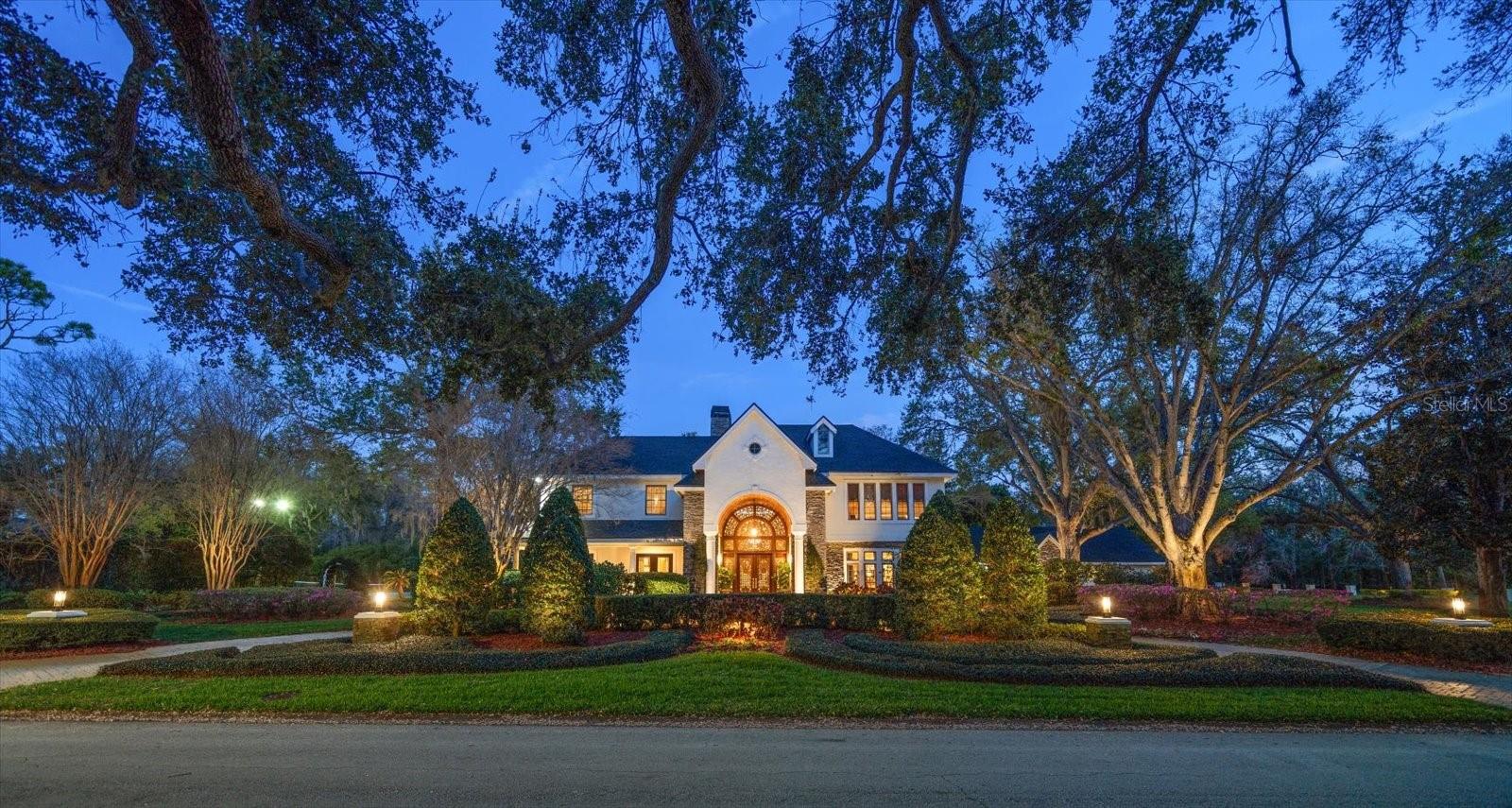 Unparalleled privacy in the heart of it all! Nestled on approximately 1.5 acres of pristine land, this custom-built Clearwater estate home is a masterpiece of quality craftsmanship and high-end finishes, including solid mahogany cabinet doors and trim work throughout, offering an unprecedented blend of luxury, comfort, and sophistication. A tumbled marble and pavered circular driveway, majestic oaks and professional landscaping lead to the show-stopping bronze and Mahogany double entry doors that hint at the grandeur within. Step inside to a breathtaking foyer, where a free-standing suspended staircase serves as the focal point, flanked by an elegant dining room, which includes built-ins with two Wolf warming drawers, and a refined living room, while a private office and convenient half bath offer added functionality. Entertain with ease at the well-appointed wet bar before making your way to the newly updated chef’s kitchen, a true culinary dream featuring striking quartzite countertops, an oversized island with prep sink and seating, and top-of-the-line stainless-steel appliances. A butler’s pantry equipped with a second dishwasher and second Sub-Zero refrigerator, and additional sink provides added convenience, while the kitchen seamlessly flows into the expansive family room, where soaring ceilings, custom built-ins with an 80 bottle wine cellar, a gas fireplace, and an abundance of windows and French doors frame picturesque views of the backyard oasis. The first floor also boasts a spacious bedroom with an ensuite bath, a game room/den with backyard access and a pool bath and sauna for the ultimate relaxation. Upstairs, a Juliet balcony and catwalk overlook the family room, leading to the magnificent primary suite, which offers a private sanctuary complete with a coffee bar, workout space, two walk-in closets, dual vanities, a spa-like soaking tub, a walk-in shower, and a separate water closet with a bidet, plus direct access to a private balcony. The secondary bedrooms provide luxurious accommodations, with two sharing a spa-like Jack-and-Jill bath, while the other features a private ensuite with a dressing table and a tub-shower combo. Step outside to the resort-style backyard oasis, where a sport court invites you to enjoy tennis, pickleball, or basketball, while multiple lounging and dining areas provide the perfect setting to entertain or unwind poolside. A fully equipped outdoor kitchen ensures effortless al fresco dining. Ideally located just minutes from premier shopping, fine dining, and an easy drive to two airports and world-renowned beaches, this one-of-a-kind estate offers the ultimate Florida lifestyle in an unbeatable location.