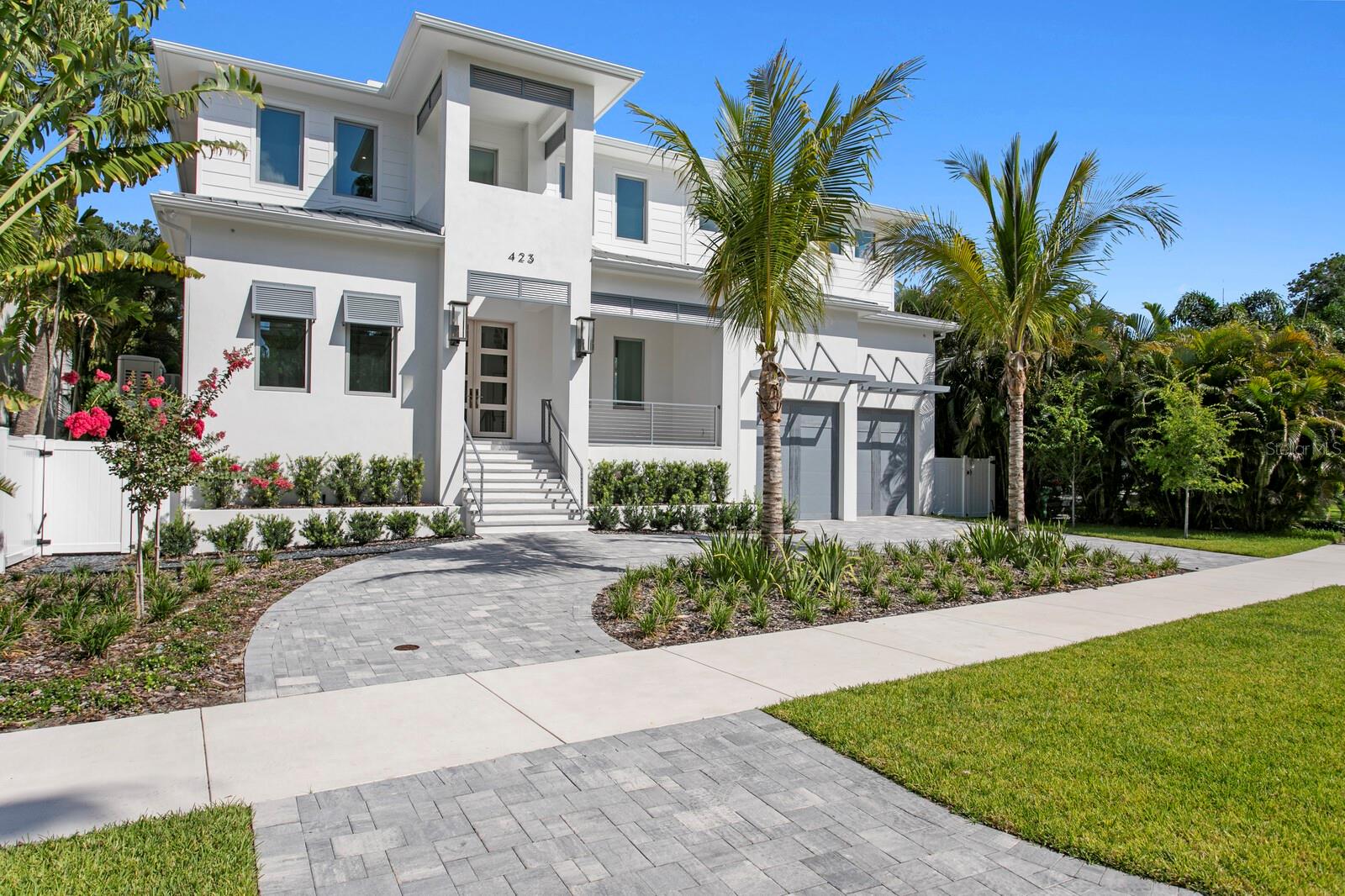 Every detail of this Modern Coastal New Construction home has been thoughtfully designed to deliver unparalleled comfort, style and sophistication in Beach Park. Perfectly positioned for privacy, this exceptional home offers state-of-the-art design features, quality craftsmanship and solid block construction, premium finishes and modern luxury. A circular driveway and grand entrance welcome you into a light-filled living area featuring soaring ceilings, rich hardwood flooring, designer lighting, fireplace and custom wine storage. An expansive wall of retractable glass doors deliver natural light while creating a seamless connection to the outdoor living spaces. The gourmet chef's kitchen showcases top-of-the-line Thermador appliances, custom-crafted wood cabinetry, an oversized center island, butler’s pantry, adjoining breakfast area and refined finishes. The main living level also features a formal dining room highlighted by a striking wood-inlay ceiling, den/office with wood-inlay ceiling, full bath, laundry room and a first level guest bedroom. Outdoors, enjoy a covered screened lanai that offers a spacious living area and outdoor kitchen, lap pool with spa, pool bath and peaceful privacy with no neighbors behind. Upstairs, the luxurious primary suite serves as a private retreat with exposed beams, sitting area and a morning bar, along with a spa-inspired bath featuring impressive finishes, an expansive glass shower and deep soaking tub, custom walk-in closet/dressing room. Three additional ensuite guest bedrooms, a generous laundry room and a spacious bonus/media room with wet bar and beverage refrigeration complete the second level. Have the very best of Florida living and the tranquility of fortified new construction in South Tampa. Additional appointments include stunning stone counters throughout, a generator and tankless water heater, irrigation system, dual laundry rooms, abundant storage and an oversized two-car garage. Located in one of Tampa's most sought-after neighborhoods, this extraordinary modern residence is convenient to the area’s outstanding Gulf beaches, top-rated schools, dining, shopping, premier sports venues, Tampa International Airport, Westshore business district and International Plaza.