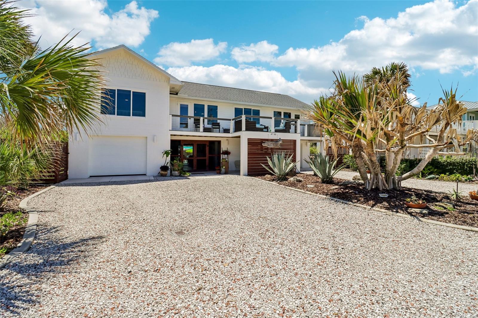 Custom-built ocean view luxury meets effortless coastal living in this extraordinary beachside retreat on sought-after Van Kleeck Drive. Perfectly positioned across from the no-drive portion of the beach, this one-of-a-kind residence was completely taken down to the studs and masterfully rebuilt in 2019, blending modern elegance, exceptional craftsmanship, and thoughtful design throughout.
From the moment you arrive, the mature landscaping, striking architecture, and impressive curb appeal set the tone for what awaits inside. The welcoming breezeway creates a seamless connection between the main home, private flex space, and resort-style outdoor living spaces. Upstairs, the impeccable open concept living area has lots of natural light. Designed for entertaining, the chef’s kitchen features an oversized quartz island, Thor six-burner gas range and custom built-in mini bar—perfect for preparing your morning coffee or evening cocktails.  The spacious living room is anchored by a cozy gas fireplace with custom built-ins.  The split-bedroom floor plan offers ultimate privacy, highlighted by the oversized primary suite with deck access, expansive walk-in closet, and a spa-inspired bath featuring dual vanities, soaking tub, and separate glass-enclosed shower. An additional upstairs guest suite is thoughtfully situated on the opposite side of the home.
Downstairs, the flex space/3rd bedroom offers a kitchenette, and convenient pool bath access through the breezeway, making it ideal for guests or multigenerational living.
Outdoor living is equally spectacular with both east-and west-facing decks which provide breathtaking views of the ocean and sunsets. The saltwater pool is both self-cleaning and self-leveling making it very low maintenance, and an outdoor shower for the ultimate beach lifestyle experience. 
Additional premium features include, an elevator, 2 separate garages- one has a workshop, lots of parking, located in a quiet cul-de-sac, a partial house natural gas generator for peace of mind, impact and hurricane rated windows and doors for enhanced storm protection and energy efficiency, and convenient central vacuum system designed to make everyday living easier. 
Every inch of this remarkable home was designed with comfort, style, and functionality in mind. Wake up to ocean breezes, spend your days by the pool or beach, and enjoy sunsets from your private deck. This is more than a home—it’s the ultimate luxury beach lifestyle on coveted Van Kleeck Drive, which is referred to by the locals as the "Park Place" of NSB.