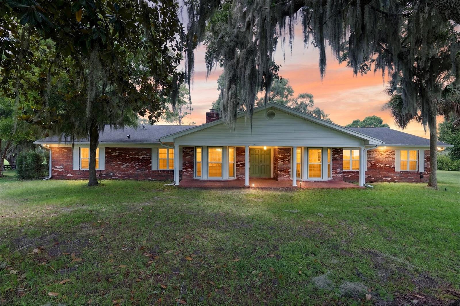 Turnkey, impeccably designed, and exceptionally well-priced, this outstanding 10-acre equestrian estate offers a rare opportunity to own a premier horse property in one of Ocala's most sought-after equestrian corridors. Ideally located just two minutes from HITS and only ten minutes from the World Equestrian Center, this exceptional farm combines a stunning concrete block show barn, a spacious and beautifully updated five-bedroom, three-and-a-half-bath ranch home, and the location serious equestrians dream of.

Designed by a professional for professionals and passionate horse owners, the centerpiece of the property is the spectacular newly constructed concrete block 10-stall center-aisle barn. Built to an exceptional standard, it features European-style stalls, elegant paver aisles, soaring ceilings, outstanding airflow, a hot and cold wash rack, feed room with sink, and an impressive rider's lounge complete with a full bathroom. Every detail has been thoughtfully planned to create a facility that is as beautiful as it is functional, allowing the next owner to move in and begin training immediately.

The 10-acre farm is equally impressive, with new four-board paddocks, panoramic views across rolling pastures, and ample level ground for a future arena or additional equestrian improvements. A scenic riding easement shaded by majestic live oaks adds even more appeal, while the barn's dedicated well and septic system ensure dependable operation.

Complementing the exceptional equestrian facilities is a spacious five-bedroom, three-and-a-half-bath brick ranch residence offering comfortable, elegant living with tasteful updates throughout. The thoughtfully designed home features expansive gathering spaces, two private primary suites—including a newly added in-law suitereat with a private entrance ideal for guests or multigenerational living—a beautifully renewed kitchen with newer appliances, generous workspace, and an oversized pantry, along with formal and informal living areas designed for entertaining and everyday comfort. A large rear patio overlooks the farm, creating the perfect setting to relax after a day with the horses.

Whether you're relocating to Ocala, expanding your training operation, or searching for a move-in-ready farm in a premier location, this exceptional property checks every box. Combining a first-class barn, a spacious and welcoming home, outstanding proximity to HITS and WEC, and tremendous value in today's market, this is a rare turnkey opportunity that is ready to enjoy from day one.