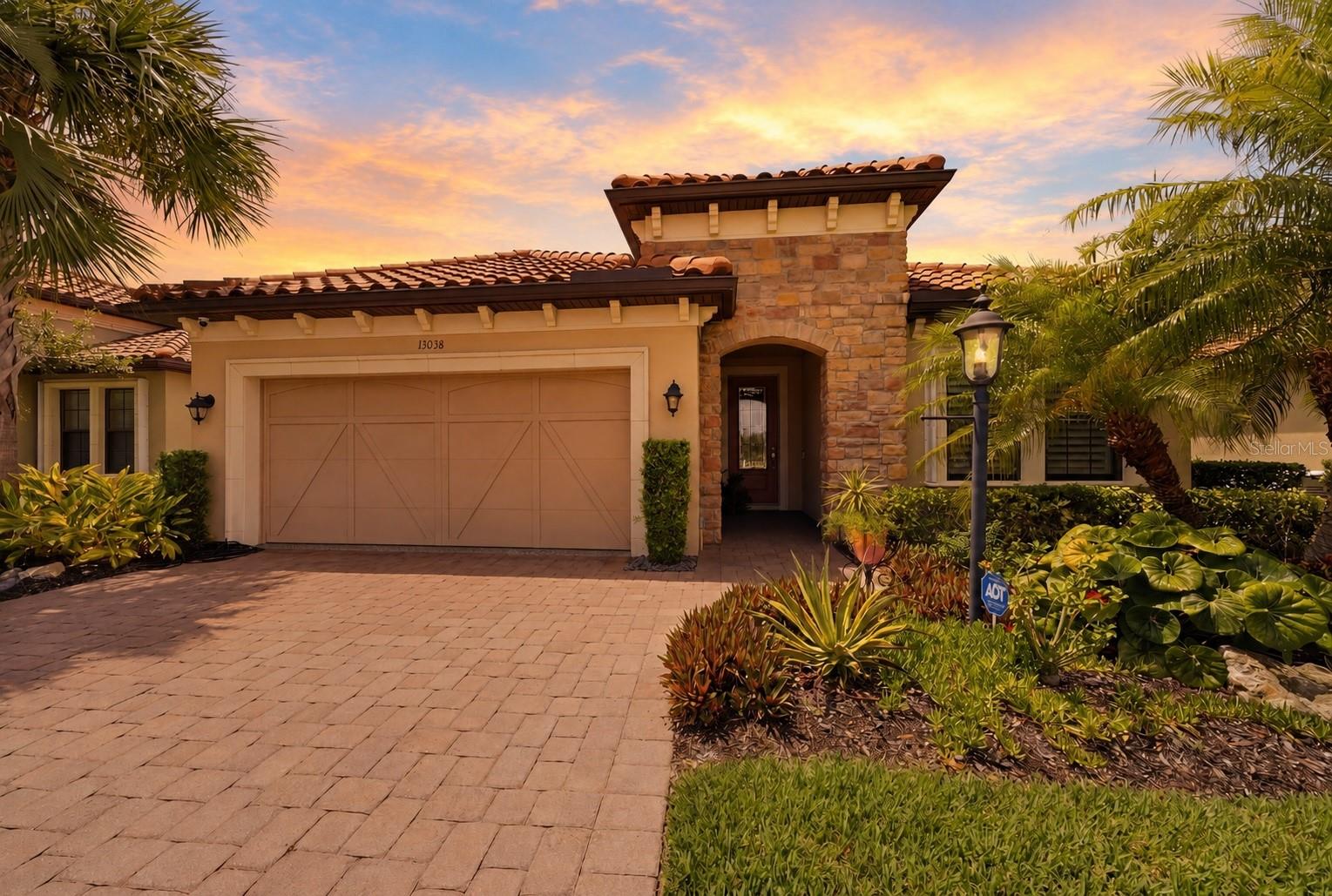 Preferred Lender is offering 1% of the loan amount as a lender credit towards buyers closing costs or interest rate buy-down on this specific home! Live like you're on vacation every day in the highly sought-after gated community of Esplanade Golf & Country Club at Lakewood Ranch. Enjoy an incredible resort lifestyle without the added expense of a golf membership. Residents enjoy an impressive collection of amenities including a resort-style pool with cabanas and the Bahama Bar, Barrel House Bistro, fitness and wellness center, spa, tennis, pickleball, bocce ball, dog parks, walking trails, a full calendar of social activities, and beautifully maintained grounds. You could easily spend the entire day without ever leaving the gates. Ideally located just minutes from UTC shopping, countless restaurants, Sarasota-Bradenton International Airport, downtown Sarasota, and the country's top-rated Gulf beaches, you'll enjoy luxury living with everyday convenience. Built by Taylor Morrison, this beautifully maintained Piceno model offers 2 bedrooms PLUS a den, 2 bathrooms, and nearly 1,900 square feet of thoughtfully designed living space. Every inch of this home has been meticulously cared for, from the beautifully appointed interior to the immaculate garage. Stepping inside, the open concept floorplan is complemented by ceramic tile flooring throughout the main living areas, plush carpeting in the bedrooms, tray ceilings, plantation shutters, Hunter Douglas motorized shades, ceiling fans throughout, and an abundance of natural light. The kitchen is sure to impress with a large Cambria quartz island, beautifully complemented by a glass tile backsplash, stainless steel appliances including a gas range and wine fridge, a custom pantry, and a built-in desk. Overlooking the dining and living areas, this space was thoughtfully designed for both everyday living and effortless entertaining. The spacious primary suite serves as a relaxing retreat, featuring two custom walk-in closets and an ensuite bathroom with split dual vanities, a step-in shower, and a private water closet. Double glass pocket doors lead into the den, complete with built-in shelving, dual desk space with LED lighting, making it the perfect home office, media room, or flexible space to suit your lifestyle. The true showpiece of this home is the exceptional outdoor living space. Sliding glass doors lead to the extended screened lanai with newer pavers, creating a seamless extension of the home's living area. The fully equipped outdoor kitchen is sure to impress with granite countertops, a built-in grill, side burner, sink, beverage refrigerator, and ice chest, making outdoor entertaining effortless. With plenty of room for comfortable seating, outdoor dining, and gathering with family and friends, this space was designed to be enjoyed year-round. Storm Smart roll-down hurricane shades provide additional protection and peace of mind while allowing you to comfortably enjoy the lanai in every season. Additional upgrades include a newer A/C and water heater (2023), whole-house generator, Ring doorbell, motion-sensor lighting, full alarm system, landscape lighting, and an immaculate garage complete with epoxy flooring, custom cabinetry, a workbench, and overhead storage. This is more than just a beautiful home. It is an opportunity to enjoy one of Lakewood Ranch's premier resort communities, where luxury, convenience, and an exceptional lifestyle come together. Schedule your showing today!