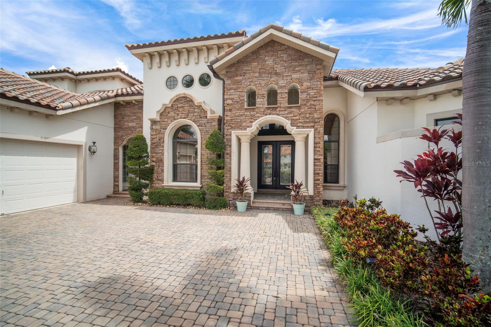 Exquisite Waterfront Estate | 200' of Shoreline..
Brand New Tile Roof (2025)..

Experience premier coastal living in this stunning John Cannon custom estate, situated on a sprawling cul-de-sac lot with approximately 200 feet of water frontage. This property offers direct lagoon access via a private dock and a 20,000 pound boat lift, making it a true standout,  in the Bay Estates of MiraBay.

Elegant Updates & Design
This primarily single-story floor plan has recent upgrades include a new HVAC system, tankless water heater, pool heater, and designer lighting.

Chef’s Kitchen: Equipped with top-tier appliances, quartz countertops, custom cabinetry, an oversized island, and a sunny breakfast nook.

Indoor-Outdoor Flow: The family room features fully retractable pocket sliding doors that open to the lanai for a seamless transition to the waterfront breeze.

Dedicated Work & Social Spaces: Includes a private home office, formal dining and living rooms, and a custom entertaining bar with integrated wine storage.

Versatile Living Spaces...
The thoughtful split-plan layout ensures privacy and comfort for all:

Primary Suite: A sanctuary featuring a sitting area, direct pool access, an oversized soaking tub, a signature walk-in shower, and custom-organized closets.

Guest Accommodations: Two additional first-floor bedrooms (one ensuite) and a pool bath with direct lanai access.

Upper Level: A remodeled guest suite with a full bath and a spacious bonus room that opens to a private balcony with sweeping lagoon views.

Outdoor Oasis
The backyard is designed for relaxation and recreation, anchored by a heated pool and spa with elegant travertine decking. The outdoor living area is completed by:

A large, spacious, outdoor kitchen and covered dining area.

A cozy fireplace and professional, lush landscaping.

Unobstructed views of the water for enjoying evening sunsets.

Additional Highlights
Custom closet systems and architectural tray ceilings.

3-car garage with epoxy flooring and upgraded storage.

Located within the gated MiraBay community.  This resort-style community has a community clubhouse, heated-resort-style Olympic swimming pool, 136 ft water slide, parks, 3 playgrounds, gym, cafe with a full liquor license, basketball courts, tennis courts, fitness center, 135-acre lagoon where you can rent kayaks and paddle away, and much, much more. You will feel like you’re living in a 5-star resort! This community has it all. This home is centrally located and convenient to Tampa, Orlando, Bradenton, Sarasota, and St. Petersburg where you can experience the best Florida beaches, shopping, and entertainment. The Florida lifestyle you've been dreaming of awaits you. Paradise awaits! Call today for your private showing.