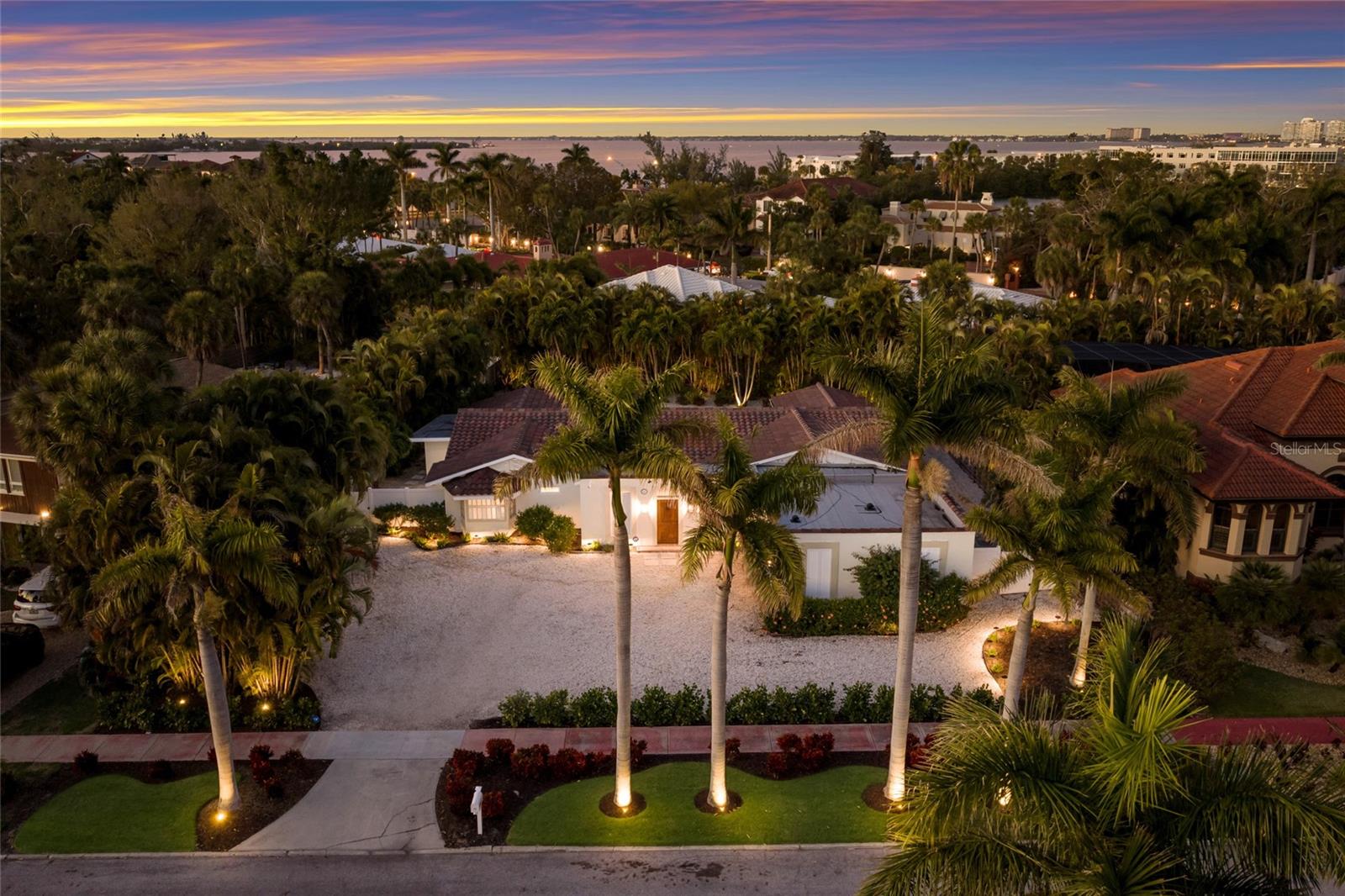 Welcome to 103 Fillmore Drive, a beautifully renovated 4-bedroom (or 3 bedroom plus den/office), 3-bath pool home with an assumable flood policy located in the heart of world-famous St. Armands Circle. Just a few blocks from the white sands of Lido Beach, this exceptional property offers the perfect opportunity as a primary residence, vacation home, or income-producing investment. The home has been completely renovated and features an open, inviting layout designed for comfortable Florida living. The living area includes a cozy fireplace and flows seamlessly to the outdoor entertaining spaces. Step outside to your private backyard oasis with a sparkling pool, tropical landscaping, bar with grill,and a firepit lounge area—perfect for relaxing or entertaining under the Florida sunshine. Major improvements include a new roof installed in 2025, kitchen and baths updated and whole home beautifully remodeled. Located just moments from the renowned restaurants, boutiques, and vibrant atmosphere of St. Armands Circle and minutes to downtown Sarasota, the home offers an unbeatable island lifestyle. With estimated rental income potential of approximately $100,000 annually, this property presents a rare opportunity in one of Sarasota’s most desirable coastal communities.