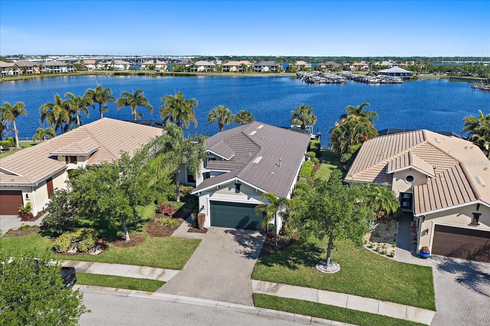 One or more photo(s) has been virtually staged. Welcome to luxury waterfront living in the highly coveted boaters paradise of Tidewater Preserve. Perfectly positioned for those who embrace the Florida lifestyle, this exceptional property offers a private dock with a 9,000-pound boat lift and direct access to open water—just a short cruise to Anna Maria Island and the Gulf. This beautifully appointed 3-bedroom, 2-bath residence with a versatile den seamlessly blends comfort, elegance, and functionality. Inside, an open-concept floor plan creates a bright, airy ambiance, ideal for both everyday living and entertaining. The spacious kitchen flows effortlessly into the living and dining areas, all enhanced by picturesque views of your private outdoor retreat. The den provides flexible space for a home office, media room, or additional guest accommodations. The primary suite serves as a peaceful sanctuary, featuring an en-suite bath and generous closet space. Two additional bedrooms offer comfort and versatility for family and guests alike. Step outside to your personal oasis, where a private pool and spa invite you to relax and unwind. The covered lanai is perfect for al fresco dining and year-round entertaining, allowing you to fully enjoy Florida’s beautiful climate. Residents of Tidewater Preserve enjoy a gated, amenity-rich lifestyle along the Manatee River, including access to a marina with boat slips, kayak launch, resort-style pool, fitness center, clubhouse, and scenic walking trails. This is more than a home—it’s an elevated waterfront lifestyle. Don’t miss the opportunity to own in one of the area’s premier boating communities.
