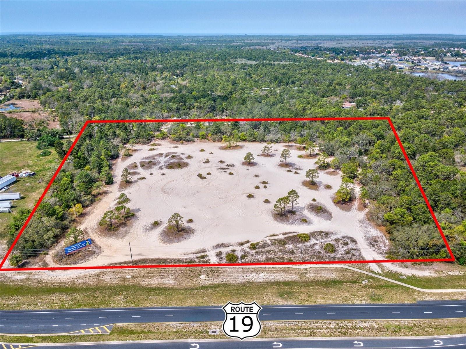 Prime commercial opportunity on busy US Hwy 19/Commercial Way featuring 15.7 acres of land, excellent highway visibility, strong traffic exposure with an AADT of 26,424 vehicles, and dual access from both Commercial Way and Clarita Street - positioning this parcel for outstanding future potential. Currently zoned agricultural, this property offers added upside with potential for commercial rezoning, making it an attractive option for a variety of commercial or mixed-use development opportunities. The existing billboard provides an additional income stream, adding immediate value while you plan for future use. Located approximately 2 miles north of Cortez Boulevard in a fast-growing area of Hernando County, the property is surrounded by shopping, dining, medical facilities, established neighborhoods, and everyday conveniences. Its location along Florida's Adventure Coast also places it near the Gulf of Mexico, Weeki Wachee Springs, and other popular area attractions that continue to draw both residents and visitors. With highway frontage, rear access, income potential, and development flexibility in a rapidly expanding corridor, this 15.7-acre parcel is a standout investment opportunity with strong long-term upside.