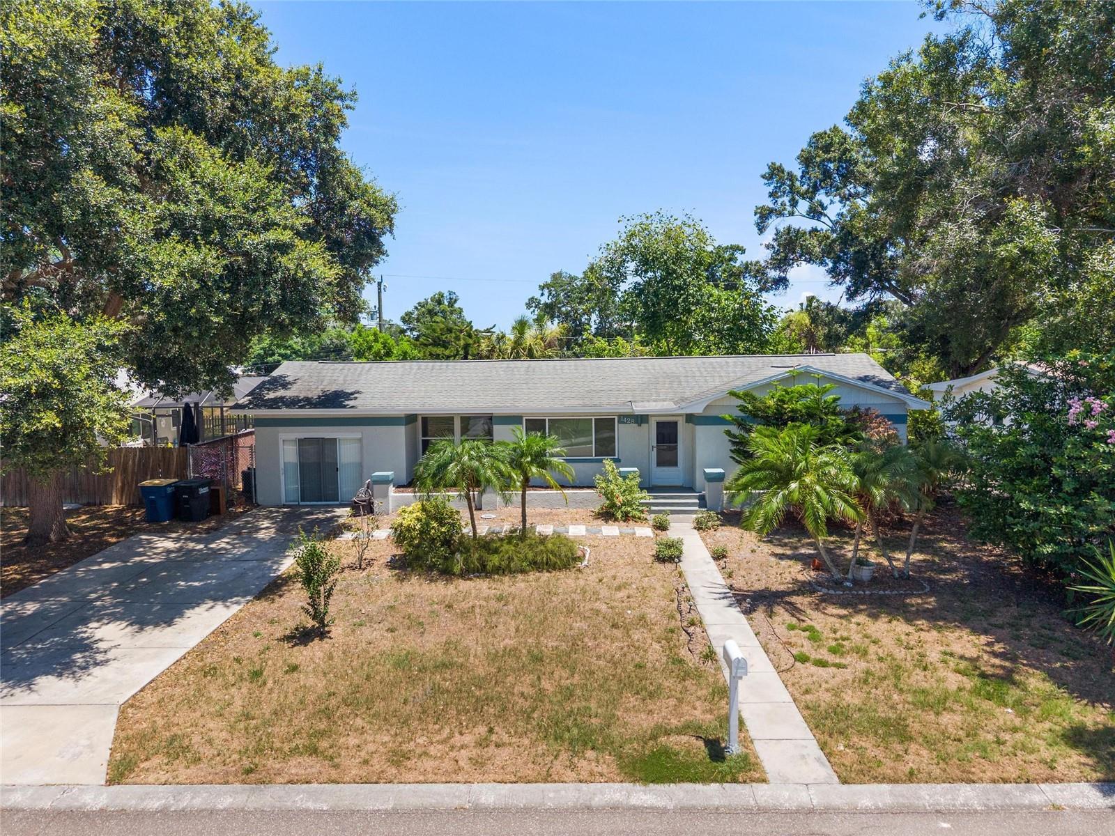 This single-family residence is in the Palm Terrace neighborhood and offers approximately 1,560 square feet of living space on a 7,640-square-foot lot. It features two bedrooms, one bathroom, a separate dining room, a family room, and a galley-style kitchen with stainless steel appliances.  There is also an additional bonus room with its own air conditioning unit and windows on three sides.  It could be used as an office, den, or extra living area.   The home has updated windows and a central air conditioner (manufactured in 2018).  The oversized garage has been converted into a closed room with an office and an indoor laundry area at the rear.  The sliding glass door entry can be replaced by a garage door if the new owner wishes to have a garage for automotive use.   The backyard is spacious and backs up to a lake, providing privacy with no rear neighbors.  The property is situated just a few blocks from the Clearwater Country Club and is conveniently located near shopping, dining, and a short drive from Clearwater Beach.