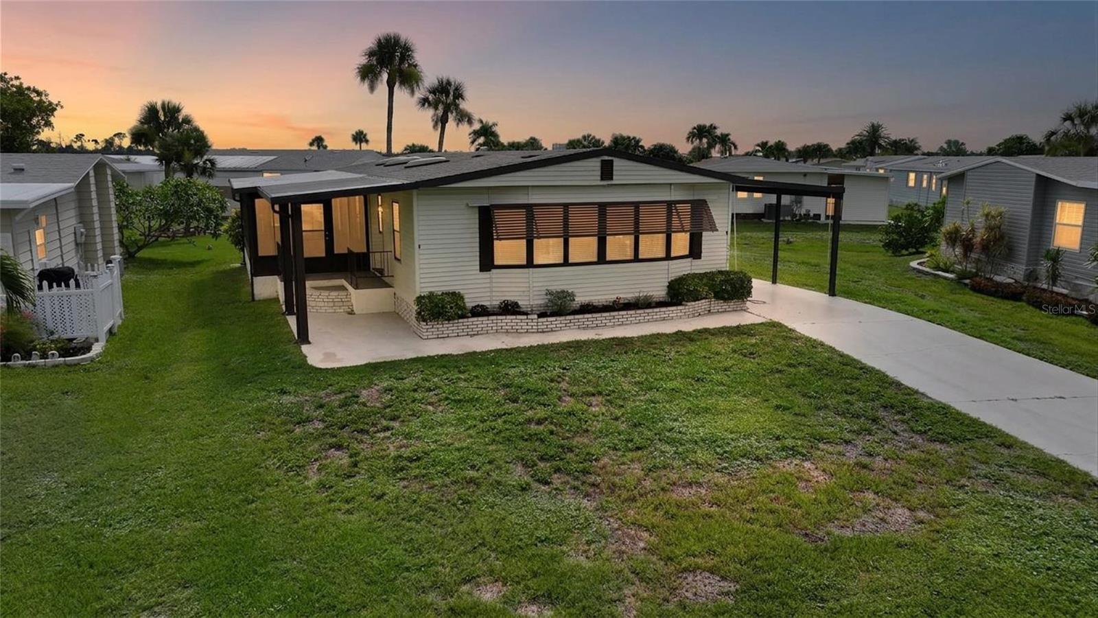Welcome to carefree Southwest Florida living in this beautifully maintained, fully furnished 2-bedroom, 2-bath manufactured home located in the sought-after 55+ community of Lee Plantation. Offering approximately 1,481 square feet of living space, this bright and inviting residence features an open-concept layout with updated wood-look flooring throughout the main living areas, spacious living and dining rooms, and abundant natural light from multiple skylights. The well-appointed kitchen provides generous cabinet and counter space, stainless steel refrigerator, built-in oven, breakfast bar, and a cozy dining nook perfect for everyday living.

The spacious primary suite offers a walk-in closet, dual-sink vanity, private water closet, and walk-in shower, while the guest bedroom and bath provide comfortable accommodations for family and friends. An oversized enclosed Florida room creates the perfect space to relax, entertain, or enjoy year-round indoor-outdoor living. Outside, you'll appreciate the covered carport, attractive landscaping, and low-maintenance yard.

Residents enjoy exceptional resort-style amenities including a heated pool and spa, clubhouse, shuffleboard courts, covered gathering areas, and beautifully maintained grounds, creating an active and welcoming lifestyle. The home is conveniently located just minutes from Fort Myers Beach, Sanibel Island, shopping, dining, golf courses, medical facilities, and everyday conveniences.

Whether you're looking for a seasonal retreat or full-time residence, this move-in-ready home offers outstanding value, comfort, and the best of Southwest Florida living. The property is located in Lee Plantation Phase 1 and was built in 1986, offering approximately 1,481 square feet with 2 bedrooms and 2 bathrooms