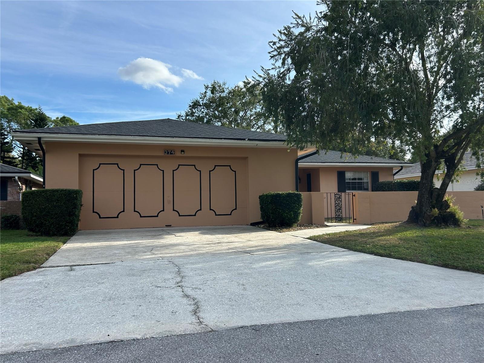 BRAND NEW ROOF INSTALLED NOVEMBER, 2025. New flooring May 2026.  Enjoy the Florida Country Club Lifestyle in this 2 bedroom patio home featuring a foyer with wet bar, spacious living room, dining area, kitchen with wood cabinets and converted Florida room, ideal as a den, office or play room. Additional amenities include an expansive master bedroom, 2 car garage with door opener and front courtyard wall. The home is in move-in condition but does have some original features and it's priced accordingly. This is an ideal opportunity to make this home your own with some contemporary updates.