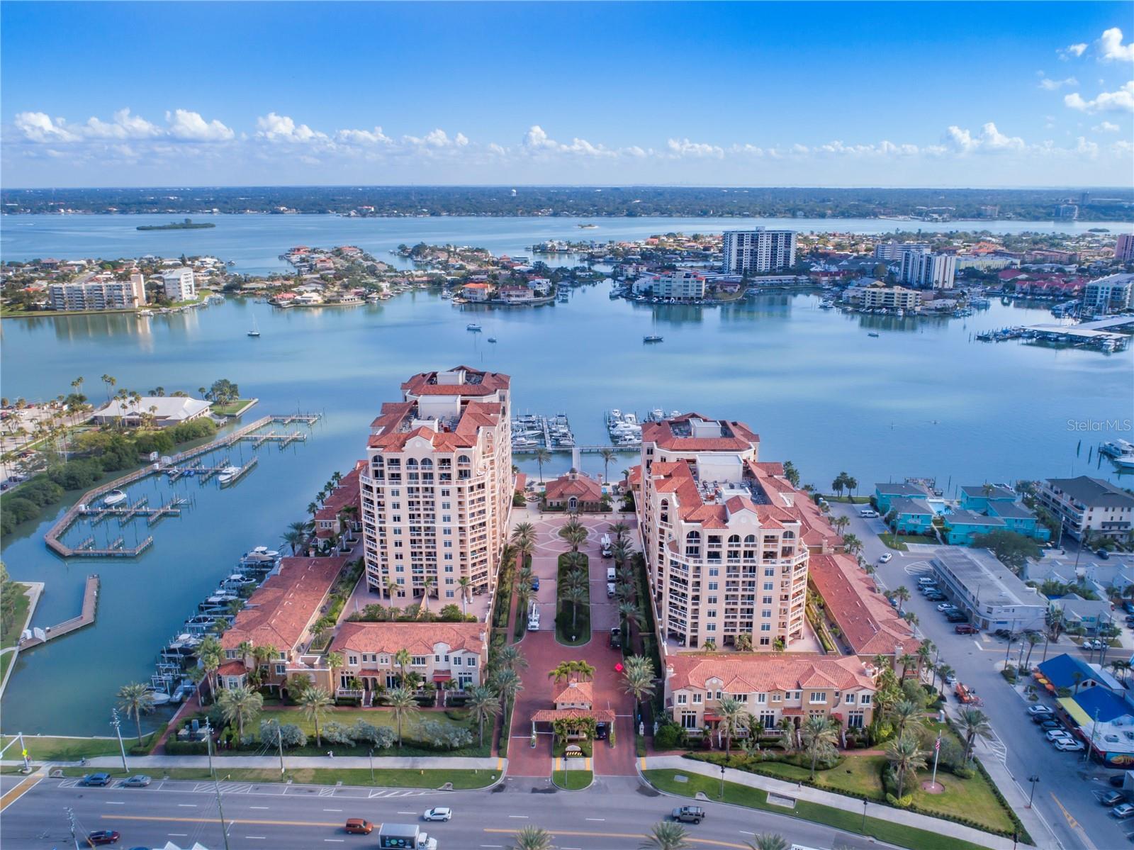 Enjoy amazing panoramic views of both the Gulf of Mexico and the Intracoastal waterways from this 7th floor unit with private & unobstructed North exposure in Belle Harbor, a beautiful Mediterranean masterpiece on the Intracoastal waterways of North Clearwater Beach. The light & bright residence features an ideal layout with split bedroom plan and open floor plan with floor-to-ceiling sliding glass doors opening to an oversized balcony. You will be delighted by the private and protected vantage of the Beach, the Bay, Mandalay Channel & Marina, Intercoastal Waterways, Island Way and Honeymoon Island. Awake to the magical sunrise colors affecting sky and sea in the master suite, which also opens to the spacious balcony. The kitchen features granite counter tops, eating bar, Stainless Steel appliances, with the laundry room adjacent to it. Enjoy all the amenities and comforts of Belle Harbor, a magnificent 6.5 acre guarded property, including 24- hr. security, lush landscaping, assigned under-building parking, climate-controlled storage units, gym overlooking the intercoastal, 65 slip marina, waterfront heated pool with spa, private beach, clubhouse with kitchen, great room, and poolside veranda. Watch TV, grill your favorites and sit comfortably enjoying the view. All this located within minutes of walking to the beach, playgrounds, restaurants & shops. Your search is over once you see this impeccable condo with breathtaking views day & night!