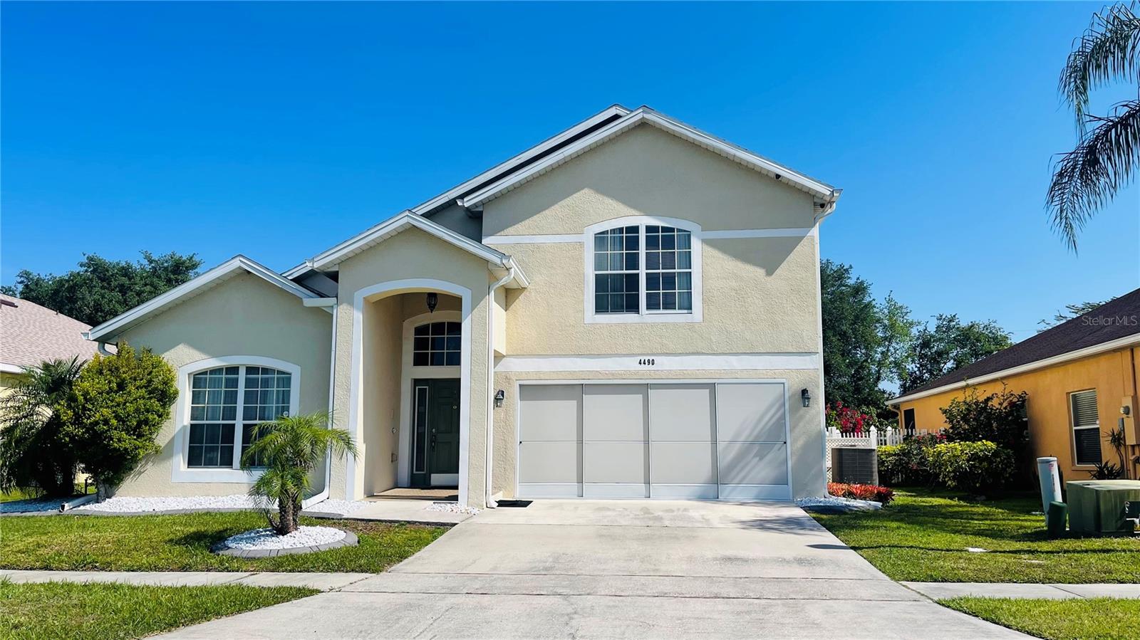 Beautiful and maintained 3,266 sq. ft. two-story home featuring 4 bedrooms, 2.5 bathrooms, and numerous upgrades throughout. Ideally situated with the front of the home facing a community park and a large fenced backyard with a covered patio overlooking another park area, this property offers both privacy and scenic views.  The home features a covered entryway, 2-car garage, laundry room, vaulted ceilings, ceramic tile flooring throughout the first floor, and carpet upstairs. Upon entry, you'll find formal living and dining rooms, perfect for entertaining. The spacious family room opens to a well-appointed kitchen complete with stainless steel appliances, pantry, center island with breakfast bar, and a casual dining area.  Upstairs, a generous loft provides flexible space for a second family room, media room, or home office. The expansive primary suite offers room for a sitting area, a large walk-in closet, and an ensuite bathroom featuring dual vanities, a garden tub, and a walk-in shower in the first floor.  Recent improvements include a NEW water heater, roof replacement in 2016, and a recently installed Tesla Powerwall solar panel system with whole-house backup battery power, providing energy efficiency and peace of mind.  It will be paid off at closing.  With a low HOA and a convenient location near schools, shopping, dining, and the vibrant Kissimmee downtown area, this exceptional home is truly a must-see!