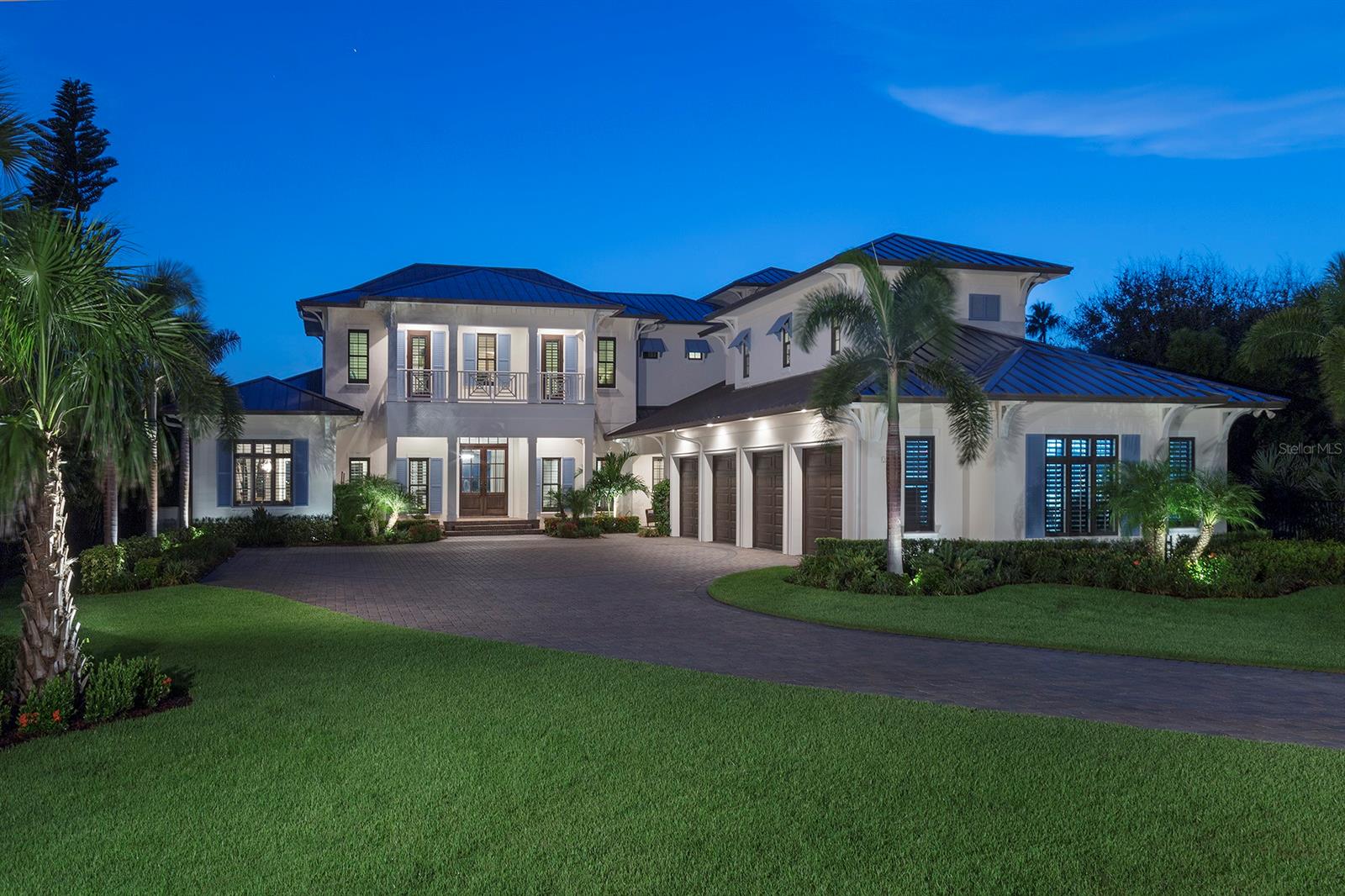 A rare opportunity to acquire this one-of-a-kind custom home built by award-winning builder Dave Brewer Homes is the epitome of tasteful luxury. Located on one of the largest Intercoastal Waterway (ICW) lots on North Beach in New Smyrna with a forever view and stunning sunsets every night. Once through the gates you will find magnificently manicured tropical landscaping that leads you up the circular motor court driveway to a four-car car collectors dream garage. The moment you step through the front doors, your eyes are greeted by expansive windows overlooking the ICW and a resort-style pool. Hardwood and brick flooring is throughout the main floor. This spectacular 6112 square foot home features four bedrooms, 4 full baths and 2.5 baths. Custom cabinetry on main floor, executive office, wine room. A kitchen that is truly a chef’s delight. Top-of-the-line stainless steel appliances, large center island, hand crafted custom hood,5 x 10 walk-in pantry and breakfast nook. Great room with gas fireplace.  Theater room with surround sound and 4K projection TV. . Primary bedroom has picturesque views of the ICW and access to the Lanai and pool. Off the great room you will find over 800 SQ.FT. of covered screened in patio with gas fireplace, outdoor summer kitchen, large island and half bath. Salt water infinity edge swimming pool with children’s wading area, dedicated spa and gas fire pit. Covered dock for 28 ft. boat with power & water. Floating dock for easy water access for a SUP, & kayak launch. Oversized four-car garage with fully finished interior including flatscreen TV, insulated garage doors, hot/cold running water, steel mechanic’s cabinetry with integrated rolling tool cabinets, hardwood work bench, WeatherTech flooring and 7,000 lbs. car lift. Walking distance to the beach and Flagler Ave. This estate is truly New Smyrna Beach luxury living at its absolute finest. All information is deemed reliable but not guaranteed & should be independently verified. ;Water: City