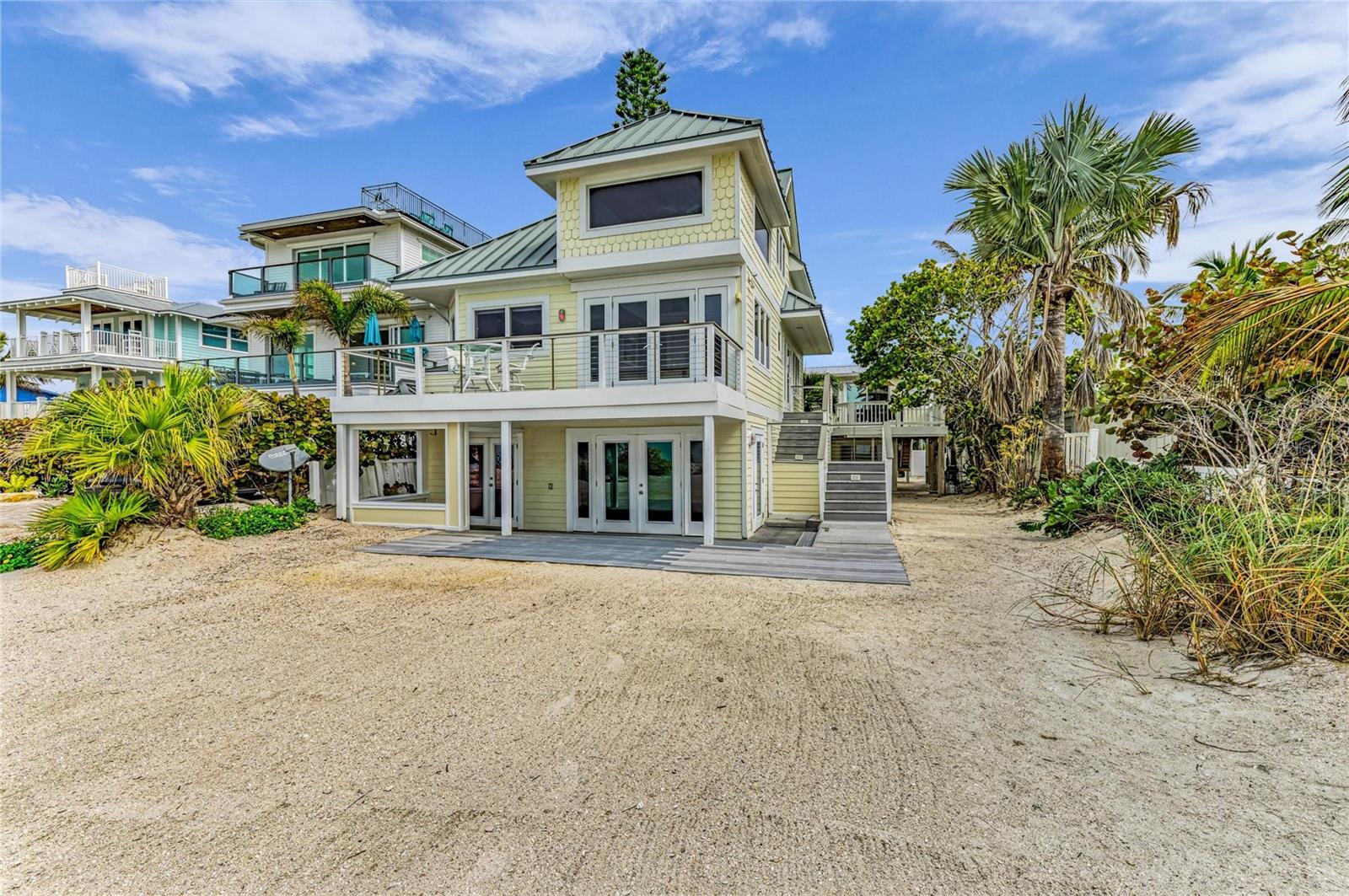One or more photo(s) has been virtually staged. Beachfront property on the sugary sands of Anna Maria Island! Experience the pinnacle of waterfront living with majestic sunsets and breathtaking Gulf views. This beachfront property offers two separate structures and is zoned as a Land-Condominium with ability to have four separate condominium units. Being sold turnkey, the beachside house offers a total of four bedrooms and four baths and can be divided into two separate condominium units. The downstairs two bedrooms, two baths are ideal for guests and family for space and privacy. The bottom floor was recently repaired and updated due to damage from Hurricane Helene. The upstairs unit is in mint condition and outfitted with cathedral ceilings, laminate floors, granite kitchen counters and stainless steel appliances. The living area provides panoramic Gulf views and opens up to the exterior balcony to enjoy grilling out and listening to the sound of crashing waves to help take away all your worries. The turnkey back house has two separate units, upstairs and downstairs, which are ideal for additional guest and rental income. The upstairs and downstairs units are being rented and have a full schedule for potential future rental reservations. Each unit offers two bedrooms and one bath. This property offers so many opportunities to make it your own. With 50-by-100 feet of non-buildable lot owned by the seller, the property offers its private beach access. It's all about the view, the beach, the aqua blue waters and sunsets. This property is being sold as three parcels. Schedule your showing today to see this amazing property.