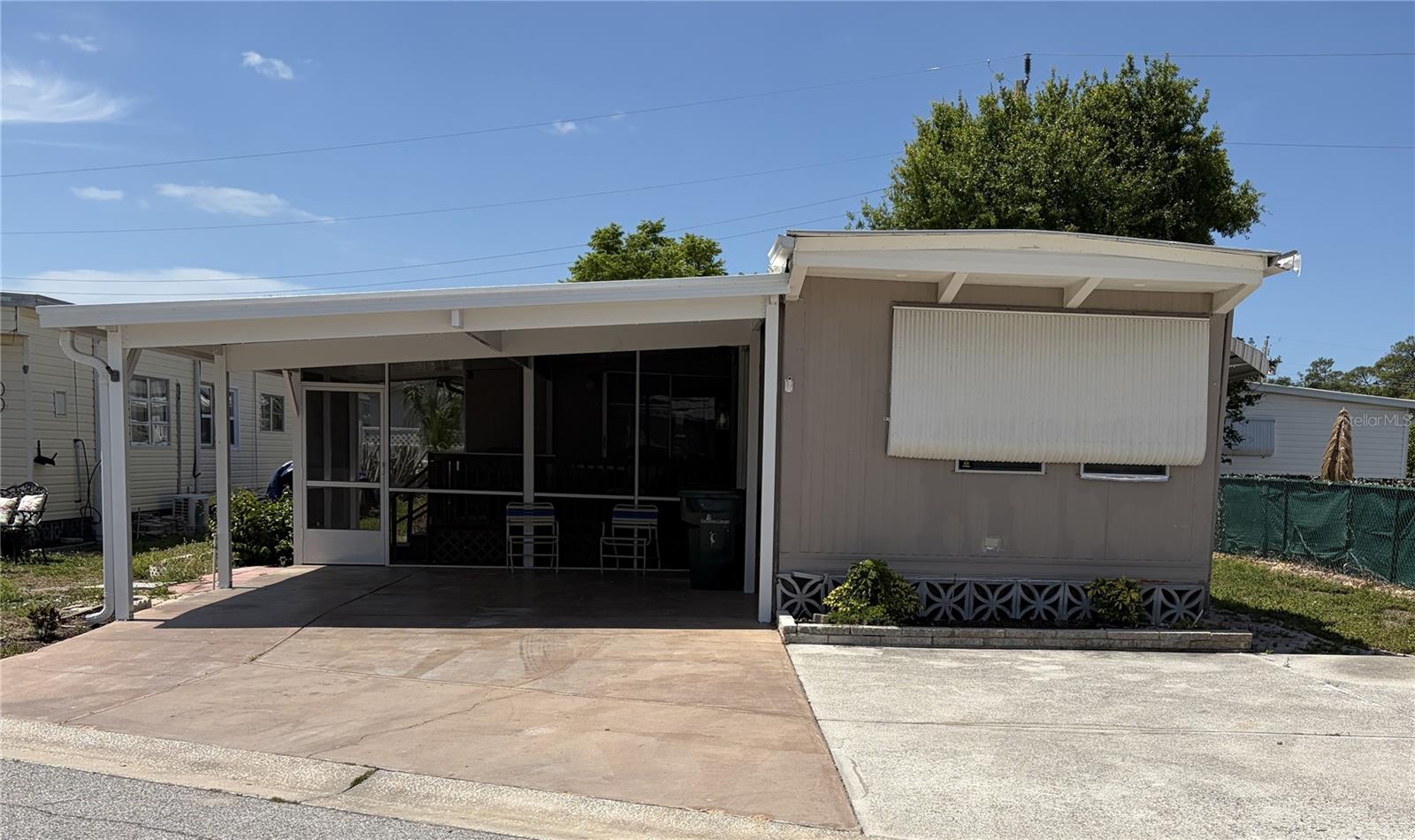 This property offers two bedrooms and 1.5 bathrooms within 915 square feet of living space if equipped with heating and air conditioning (2021).  A third room in the house can be used as a bedroom, den, or office. The home presents an excellent opportunity for renovation, with abundant possibilities for creative updates. Recent improvements include a new carport and a screened-in porch. The washer and dryer are conveniently located inside the residence, and a functional outdoor shower is also available.
Tri-par Estates is a 55+ community that provides a wealth of amenities: enjoy a heated and cooled large pool for year-round swimming, a brand-new spa, tiki hut, pickleball courts, fitness center, shuffleboard, miniature golf, horseshoes, and various recreation hall rooms equipped with ping-pong, billiards, card tables, a kitchenette, sewing areas, and more. The expansive clubhouse regularly hosts dinners, dances, and other events.
Situated only minutes from downtown Sarasota, you’ll have easy access to marinas, shopping, restaurants, museums, the world-renowned Siesta Key and Lido Key beaches, and Sarasota airport.
In this special park and recreation district, residents own their land directly, with no separate HOA fees—an annual fee of $1,648 is included in your property taxes. Internet and TV included in the annual fee This is also a golf cart-friendly community with optional RV or boat storage when available. Don’t miss the opportunity to join this lively, well-established neighborhood in paradise.