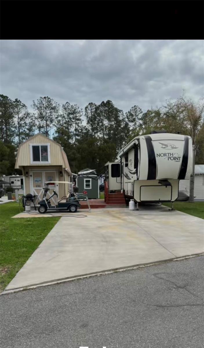 Own your piece of paradise in the highly sought-after Wilderness RV Resort in Silver Springs, Florida! This deeded 0.07 acre RV lot is located in a welcoming 55+ gated community nestled alongside the breathtaking Ocala National Forest, offering the perfect blend of nature, relaxation, and resort-style living. The lot is fully set up for comfort and convenience, featuring a large deck ideal for entertaining or enjoying Florida's beautiful weather, along with an 8x12 shed that includes a pull-down aluminum staircase leading to a spacious 8x16 loft - perfect for extra storage. Whether you're looking for full-time living, a seasonal snowbird retreat, or a great investment opportunity, this property offers incredible flexibility. Residents enjoy resort-style amenities including heated swimming pools, spa/jacuzzi, clubhouse, fitness centers, walking trails, and a vibrant community atmosphere. The affordable HOA fee includes lawn maintenance, water, and sewer, keeping ownership simple and low maintenance. Owners are responsible only for electric and propane. With the Ocala National Forest just minutes away, you'll have endless opportunities for hiking, kayaking, fishing, wildlife viewing, and exploring Florida's natural beauty. Whether you're escaping the cold winters or looking for a relaxing year-round retreat, this RV lot offers the lifestyle you've been dreaming of! Schedule your appointment today!