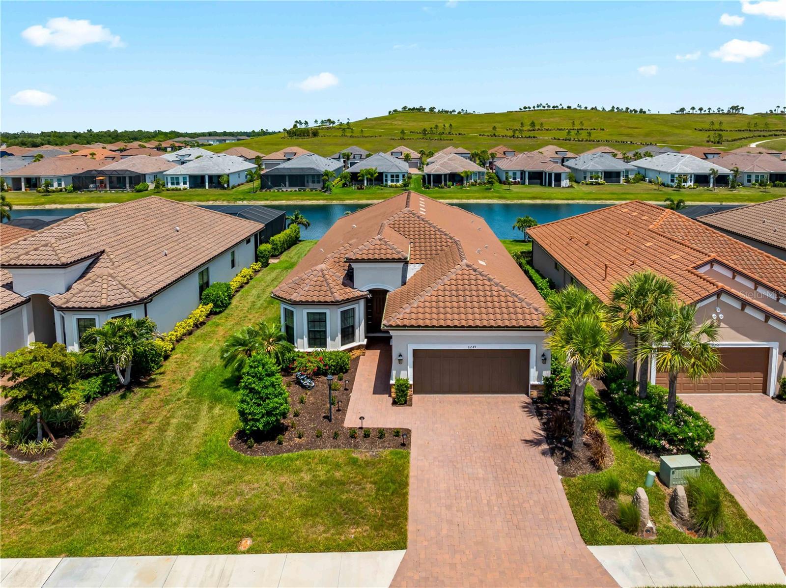 Live the Florida Resort Lifestyle – No CDD Fees & Luxury at Every Turn!

Welcome to your private Florida retreat—an impeccably upgraded and maintained pool home tucked inside one of the area’s most sought-after gated Esplanade communities. Featuring 3 bedrooms, 3 full baths, a dedicated home office, and high-end finishes throughout, this home blends upscale comfort with effortless entertaining.

Love to cook? You’ll appreciate the rare and highly desirable natural gas cooking both indoors and out. The gourmet kitchen showcases a premium gas cooktop, perfect for any home chef, while the outdoor kitchen with a built-in gas grill makes al fresco dining and poolside gatherings seamless.

Step outside to your extended screened lanai and sparkling pool overlooking a peaceful, man-made waterway—the ideal setting for entertaining or unwinding at sunset.

Inside, the open-concept design is filled with natural light, soaring ceilings, and thoughtful builder upgrades throughout, brand new carpets in the bedrooms—truly move-in ready.

Golf enthusiasts will love the proximity to world-class courses, including The Concession Golf Club, Waterlefe Golf & River Club, River Strand Golf & Country Club, and IMG Academy Golf Club.

Enjoy being just minutes from top destinations like The Mall at University Town Center for premier shopping and dining, vibrant Downtown Sarasota and Downtown Bradenton, charming St. Armands Circle, and the stunning shores of Bradenton Beach and Siesta Key Beach—all within a 16-mile radius.

Community Features Include:

Gated entry for privacy and security
Resort-style pool & spa
Elegant clubhouse & social spaces
Fully equipped fitness center
Tennis & pickleball courts
Scenic walking and hiking trails directly behind the home
Residents also enjoy access to shared amenities across other Esplanade communities—all with no CDD fees.

Whether you’re searching for a full-time residence, a seasonal escape, or a smart investment, this home delivers the Florida lifestyle at its finest.