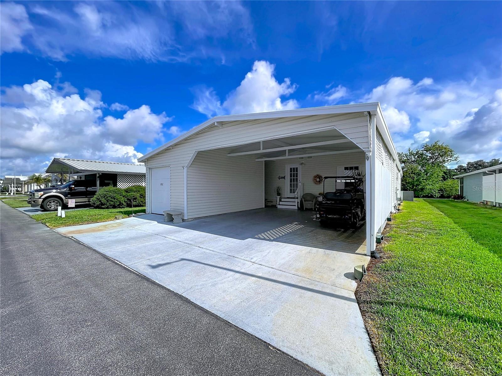 Welcome to 2055 S Floral Avenue, Lot 192, a beautifully maintained waterfront manufactured home in Bartow offering a spacious and comfortable floorplan with thoughtful updates and features throughout. Public records reflect approximately 1,352 square feet of living area, and this home makes the most of every space with drywall interior walls throughout, double-pane windows, and a large enclosed Florida room with climate control—perfect for relaxing, entertaining, or enjoying the peaceful water frontage year-round. The home is also wired with a portable generator adapter for added convenience and peace of mind. Outside, you’ll find a large two-car carport plus an additional small car or golf cart garage bay, providing excellent parking, storage, and flexibility. Immaculately cared for and move-in ready, this property offers the perfect blend of comfort, functionality, and Florida living.