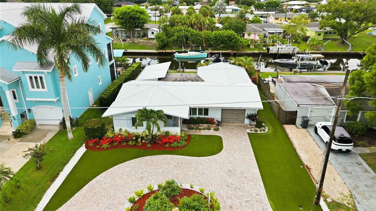 Direct access to the Manatee River with no lift or fixed bridges puts boating, fishing, and waterfront living right outside your back door. Beautifully updated from top to bottom, this canal-front home offers the rare combination of high-end finishes, major system upgrades, and the freedom of no HOA or lease restrictions.

A circular paver driveway, lush Florida-friendly landscaping with artificial front lawn and drip irrigation, and exceptional curb appeal create an inviting first impression. Inside, the split floor plan features 24x48 rectified porcelain tile throughout, a stunning remodeled kitchen with custom cabinetry, quartzite countertops, and newer appliances, plus a spacious living room centered around a stylish electric fireplace that also provides supplemental heat. The Florida room adds flexible living space perfect as a dining room, family room, or home office.

Wake up to canal views from the primary suite, complete with tray ceiling, a large walk-in closet, and a beautifully renovated ensuite featuring a dual sink vanity with lighted mirrors, a rain shower, glass enclosure, and private water closet.

Designed for enjoying the Florida lifestyle, the oversized screened lanai features an insulated roof with two ceiling fans and a remote-operated retractable screen, leading to a paver patio with a firepit overlooking the water. The private dock includes electric, water, and a 10,000-pound boat lift with new motors, making it easy to head out on the water whenever you choose.

For added peace of mind, the home also offers hurricane-impact insulated windows (adorned with plantation shutters), sliders, and impact garage door, a 2025 HVAC system, new sanitary lines beneath the slab, and a professionally installed Mosquito Masters misting system--the definition of thoughtful upgrades in all the right places.  Located just minutes from shopping, local restaurants, golf courses, marinas, and the beautiful Gulf beaches, this move-in-ready waterfront home offers the Florida lifestyle you've been looking for—simply bring your boat and start enjoying today.