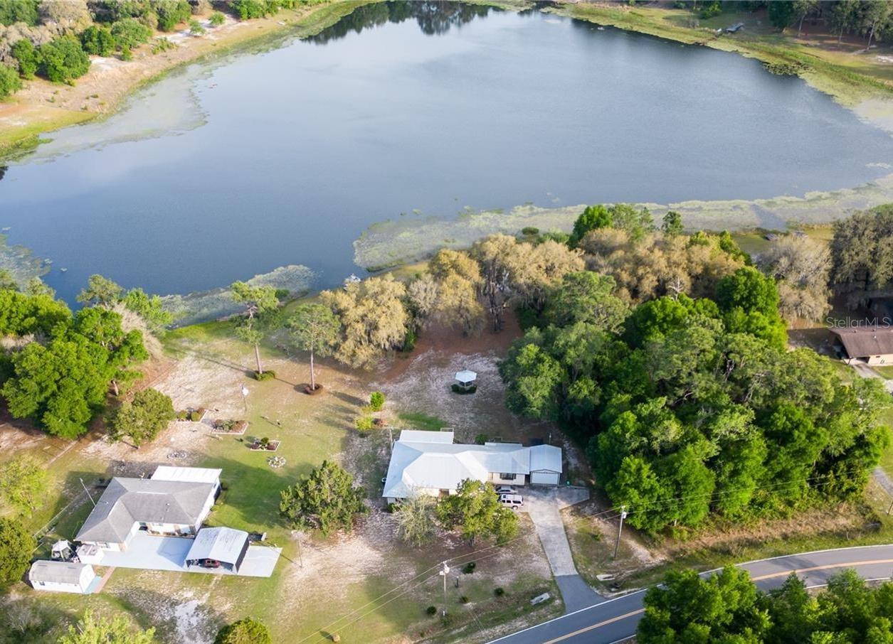Lakefront living with built-in income potential! This well-maintained home sits on a landscaped 1.19-acre high and dry lot in a quiet neighborhood just minutes from downtown historic Melrose. 3 bedrooms, 3 full bathrooms (main residence is 2 bed / 2 bath), an open flow, tons of storage, and a fully screened patio w/ hot tub. Additionally, there is a 900-sqft semi-finished basement with drywall, electrical, and plumbing. Use it for massive storage, finished into a private office space, etc. Separate storage area for lawn mowers and yard tools plus a 1-car garage and ample additional driveway parking. A full efficiency apartment with kitchen and full bathroom is currently rented for almost $1,000/MO on a short-term lease. Perfect for passive income, the perfect in-law suite, or a guesthouse. All of this in a prime location less than 30 minutes to Gainesville and just 5 minutes up the road to the almost 6,000-acre Lake Sante Fe public boat launch! Welcome Home!