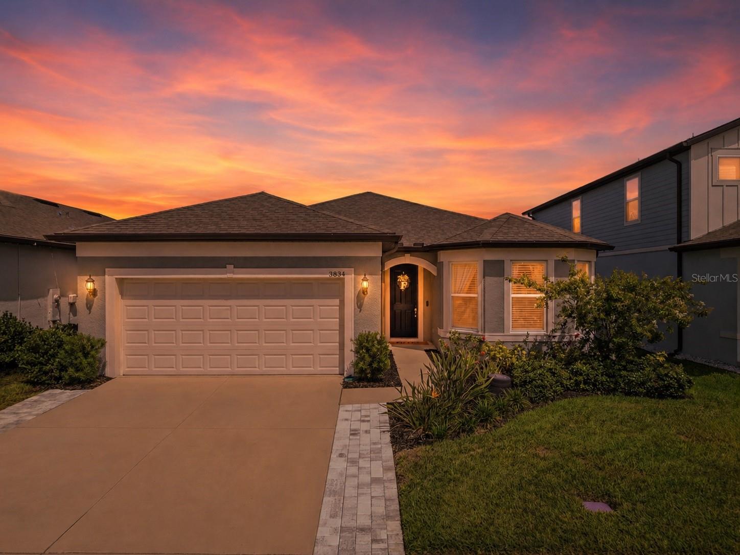 Welcome to this beautifully upgraded 3-bedroom, 3-bathroom home, perfectly positioned in one of Land O' Lakes' most desirable gated communities. Filled with natural light and meticulously maintained, this home showcases thoughtful upgrades, designer finishes, and pride of ownership throughout.
From the moment you step inside, you'll appreciate the open-concept design, luxury vinyl flooring, custom molding details, and elegant touches that make this home truly stand out. At the heart of the home is a stunning chef-inspired kitchen featuring quartz countertops, double crown molding, a built-in wall oven and microwave, gas cooktop, LG dishwasher with bottle wash feature, stylish Crate & Barrel pendant lighting, and a spacious island with built-in trash receptacles—perfect for gathering with family and friends.
The spacious front bedroom features beautiful bay windows that flood the room with natural light, while a second guest bedroom enjoys its own dedicated full bath, creating ideal accommodations for family or visitors. The owner's suite offers a private retreat complete with custom closets, dual quartz vanities, timeless subway tile accents, and a large frameless walk-in shower.
A flexible bonus space provides endless possibilities—whether you envision a home office, playroom, fitness area, reading nook, or creative space. Additional features include custom cordless blinds, a well-appointed laundry room with cabinetry, a dedicated storage room, smart home technology, and pre-wiring for an EV charger.
Step outside to a covered lanai overlooking a spacious, fully fenced backyard with plenty of room to entertain, play, garden, or simply relax and enjoy Florida's beautiful weather. The extended paver driveway adds both curb appeal and everyday convenience.
Beyond the home, residents enjoy exceptional community amenities including a resort-style walk-in pool with splash pad, outdoor lounge areas, large-screen TV's, grills, cornhole, hammocks, walking trails, playground, and dog park. HOA dues include gated access, internet, and basic cable.
Conveniently located between US-41 and Sunlake Boulevard, this quiet gated community offers easy access to top-rated schools, shopping, dining, and entertainment while maintaining the peaceful neighborhood atmosphere buyers are searching for.
This is more than just a home—it's a lifestyle designed for comfort, connection, and enjoying the very best of Florida living.
