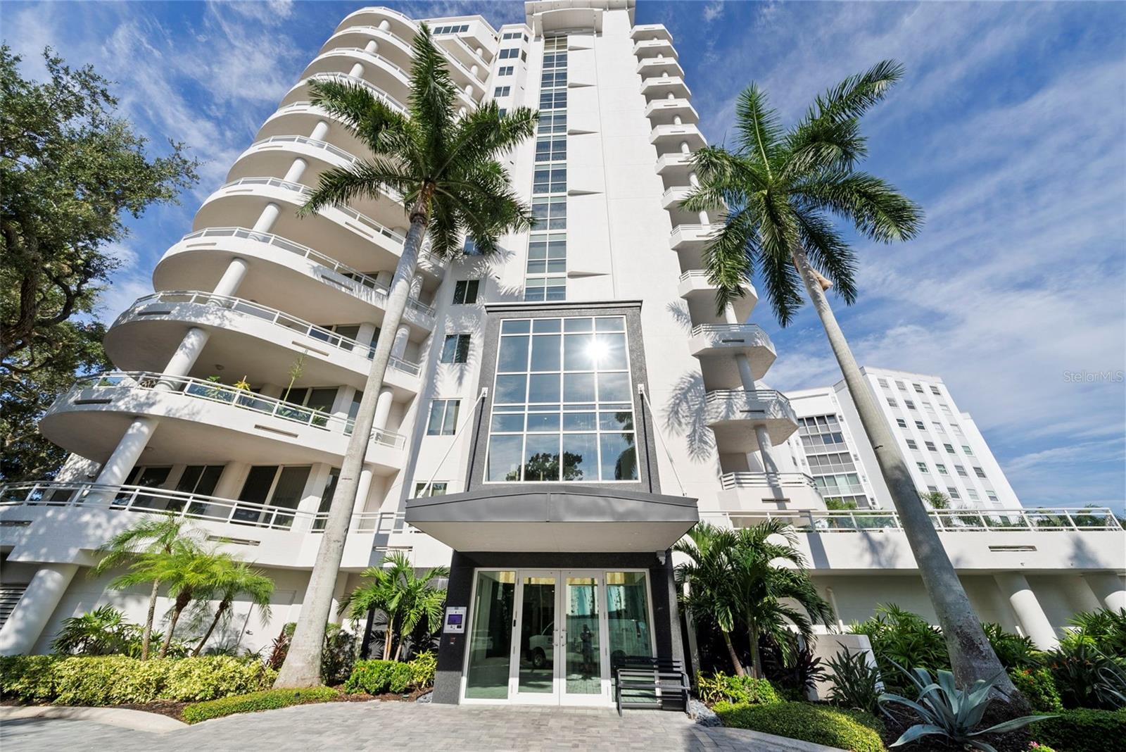 PANORAMIC WATER VIEW OF SARASOTA BAY AND NEWLY RENOVATED! Welcome to Tessera, located on the historic and iconic Palm Avenue in Downtown Sarasota. One of the rare opportunities to experience sky living with a highly sought after full water view of Sarasota Bay, the yachts at Marina Jacks, the John Ringling Causeway Bridge that leads to the barrier islands of St. Armand’s, Lido Key, Longboat Key and breathtaking sunsets daily. This residence has a highly sought after view with a location that is has an eclectic mix of art galleries, one of a kind finds and the vibrance of living in a quaint neighborhood with easy access to anywhere in the downtown area, making this the epitome of luxury living in Sarasota. This 3 bedroom, 2.5 bath plus den and a two-car garage is offered at $3,395,000. This newly renovated condo with semi-private access to its location on level 8 has been perfectly and professional designed all throughout. The grand double doors with detailed panels open to a spacious foyer that immediately showcases a water view. The primary bedroom is privately located and separate from the guest en-suite bedroom. It includes features such as a spacious en-suite sanctuary off the primary bedroom. Offering a vanity area that includes beautiful crystal lighting, a quartz countertop, brushed nickel hardware and a beveled mirror. There are two walk-in closets with built-in shelving, an Ove soaking tub with handheld sprayer, a rain shower head with multiple functions, that also include a massage feature. This en-suite bathroom offers natural light which is not always found in many other condos.The primary bedroom has built-in reading lights, room for a reading chair and access to the terrace to enjoy the sunrise with your favorite cup of coffee. The luxury vinyl light oak flooring throughout creates consistency and flow to the residence. The second bedroom has an en-suite bathroom with accent walls that includes wallpaper that elegantly ties in the finishing color palette. The vanity with granite counter top has plenty of storage, double sconce lighting and overhead recessed lighting. The shower has beautiful floor to ceiling porcelain tile, an ANZZI shower head, sprayer and advanced settings. Access to the outdoors is also available with a private terrace that includes a water view. There is a powder room conveniently located for guests. The vanity has a quartz countertop, VIGO faucet, sconce l lights on the side of the mirror plus an overhead chandelier. A third guest bedroom with double doors could be utilized in a variety of ways. There is also a room that is perfect for a den or library. The living room has a panoramic view of Sarasota Bay.  It is the perfect place for entertaining friends and family. The kitchen is designed with the most functionality possible. Since it is semi-open to the great room, it also provides an inviting way to keep prepared meals behind the scenes when entertaining. There is counter seating for two at the island, a dry bar area for pouring and serving your favorite house wine from the Sub-Zero wine tower and a walk-in pantry for storing non-perishable items. The GE oven has multiple functions such as convention and air frying. There is also a stainless-steel Wolf Range that provides optimal ventilation when preparing meals. There is also the added benefit of accessing the terrace from the kitchen as well. MAKE YOUR NEXT MOVE EXCEPTIONAL! Schedule your private showing with Lisa Otte soon.
