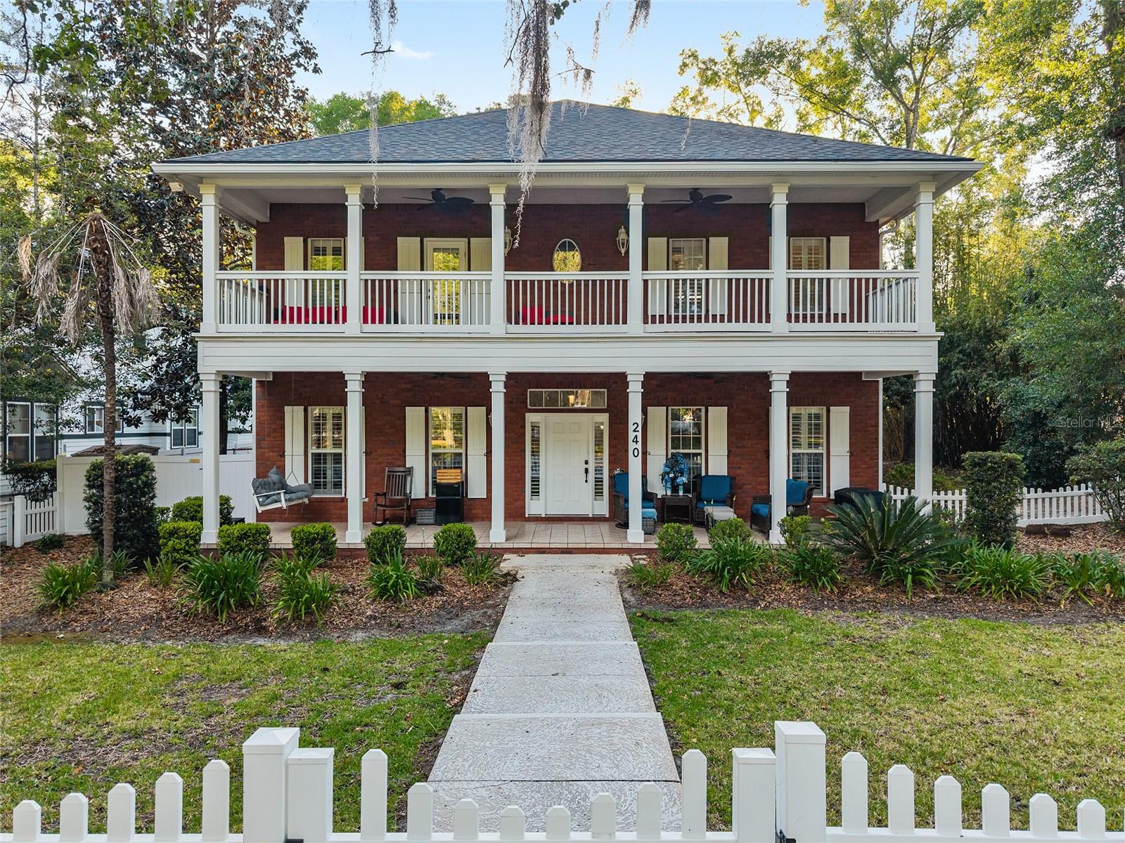 Welcome to one of Tioga's most charming and walkable homes, where timeless design, thoughtful updates, and an unbeatable location come together to create a truly exceptional lifestyle. This is one of the few brick homes in Tioga, perfectly positioned overlooking the Esplanade with just a short stroll to Tioga Town Center, this former E.G Gonzalez Parade Home offers the rare opportunity to enjoy community events, dining, shopping, coffee shops, and seasonal celebrations right outside your door. One of the things homeowners love most about Tioga is its sense of community, from holiday lights and neighborhood gatherings to friendly walks through the tree-lined streets. Inside, soaring 22-foot ceilings and abundant natural light create a stunning first impression that draws you into the great room, while the oversized kitchen island serves as the heart of the home, perfect for entertaining, holiday gatherings, casual family meals, and making memories with friends and loved ones. The flexible first-floor bedroom provides endless possibilities, serving beautifully as a guest suite, home office, playroom, or multi-generational living space with convenient access to a full bathroom. Large primary suite opens onto stunning second story balcony and includes double closets and spacious ensuite bathroom.
Step outside to enjoy your private saltwater pool, serenity of the fountain, spacious porches, and inviting outdoor living areas designed for relaxing and entertaining year-round. Whether hosting poolside gatherings or enjoying a quiet evening overlooking the neighborhood, this home embraces the best of Florida living. Equally impressive are the many thoughtful updates that provide peace of mind for years to come, including a new roof (2022), tankless water heaters (2024), HVAC systems replaced in 2019 and 2021, new pool pump (2024), leaf gutter system (2022), improved rear drainage system (2022), updated lighting,  outdoor shutters, and upgraded outdoor ceiling fans. The home also features solar panels to help support long-term energy efficiency. This is more than a home, it's a chance to experience the Tioga lifestyle that residents cherish. Come see why so many fall in love with this remarkable community.