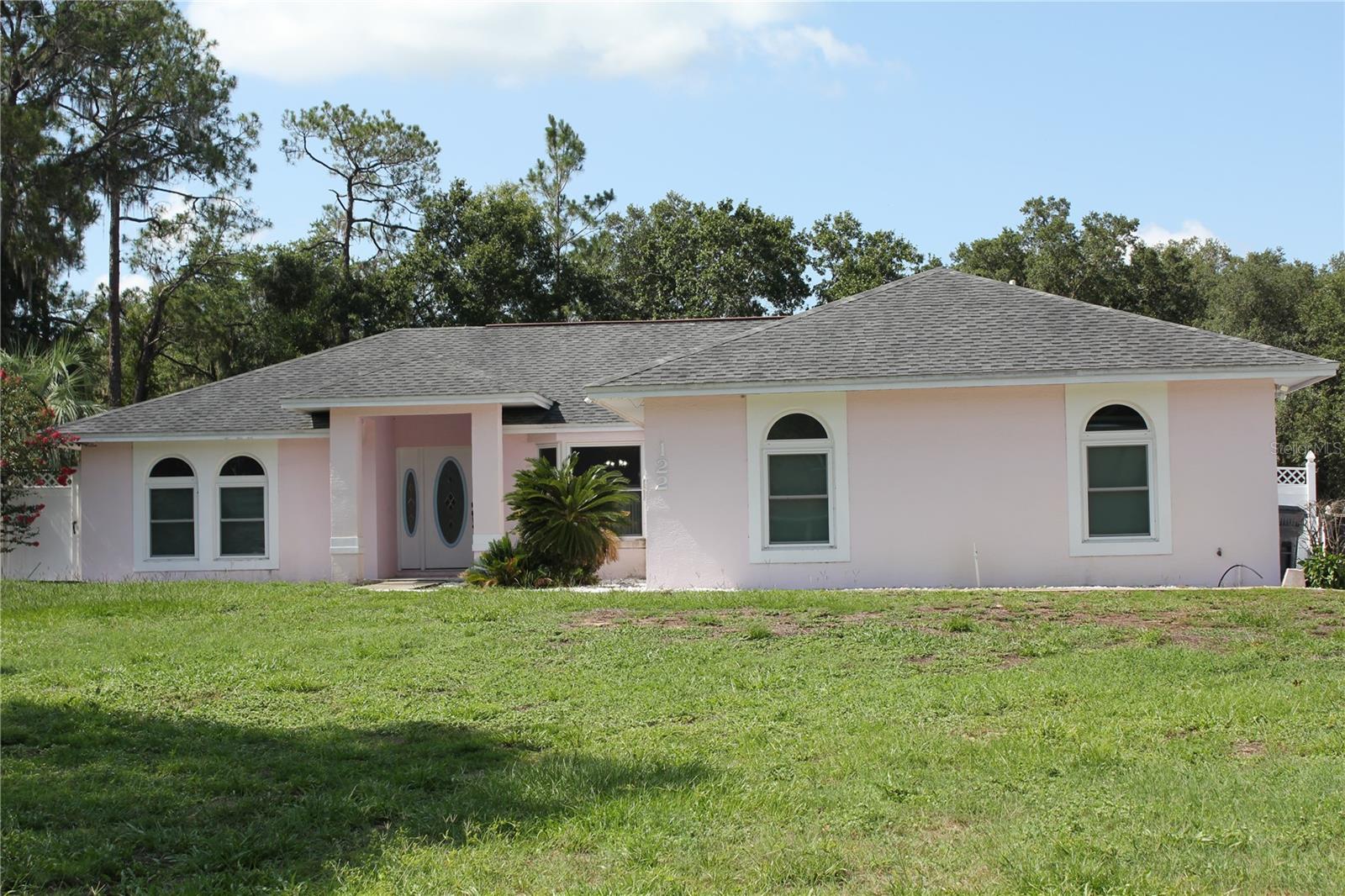 Welcome home to this well-maintained 3-bedroom, 2-bath plan offering 1,666 square feet living on over a 1/2 acre of land, and no HOA!!!  The desirable split floor plan provides privacy and functionality, while the spacious living area is perfect for everyday living and entertaining.  The kitchen comes complete with all appliances, indoor central vacuum system, and the home includes a security camera system for added peace of mind.  Step outside to enjoy the large screened lanai overlooking a sparkling in-ground saltwater pool, complete with a solar heating system to extend your swimming season.  Bring all your toys-there is plenty of parking, including a large camper/RV carport 29x11 and an additional storage shed.  The fully fenced backyard offers privacy and ample space for pets, outdoor activities, and family gatherings.  Conveniently located and move-in ready, this property combines comfort, flexibility, and outdoor enjoyment without the added expense of HOA fees.  Schedule your private showing today!