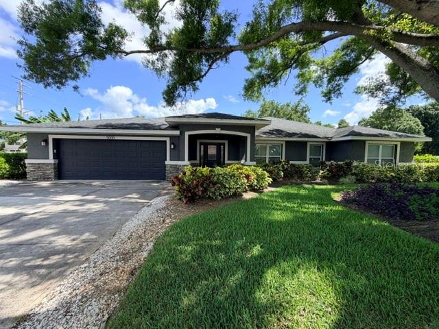 Beautifully appointed 3-bedroom, 2.5-bath split floor plan home on a desirable corner lot, surrounded by lush tropical landscaping including hibiscus and banana trees. Designed for both comfort and elegance, the home features tile flooring throughout the main living areas, tray ceilings in the living room and bonus room, and a cozy working fireplace that creates a warm, inviting atmosphere.

The expansive kitchen is a standout, offering quartz countertops, stainless steel appliances, solid wood cabinetry, and soft-close hinges—perfectly suited for entertaining, vacation stays, or everyday luxury living. The private primary suite is thoughtfully separated, providing a true retreat with a spa-like en suite bathroom featuring a large walk-in shower with an 8-jet multifunction panel and an oversized walk-in closet.

Built with quality and peace of mind in mind, the home includes hurricane impact-resistant windows and sliding doors, along with hurricane panels for entry doors and bathroom windows. Step outside to enjoy the newer screened porch (2023) overlooking the beautifully maintained, irrigated yard—ideal for relaxing after a day at the beach or on the course. Major updates include HVAC (2024), water heater (2022), and roof (2018).

No HOA or deed restrictions allow flexibility for full-time living, seasonal use, or strong Airbnb/short-term rental potential. Located near the Bradenton Country Club and close to G.T. Bray Park, this home is perfect for those who enjoy both golf and an active outdoor lifestyle. You’ll also appreciate being walking distance to dining, shopping, and transportation for ultimate convenience.

Just minutes to the stunning beaches of Anna Maria Island, this property is perfectly positioned for golfers, beach lovers, and investors alike. Experience the ideal blend of coastal living, flexibility, and location—don’t miss out on this exceptional opportunity!
