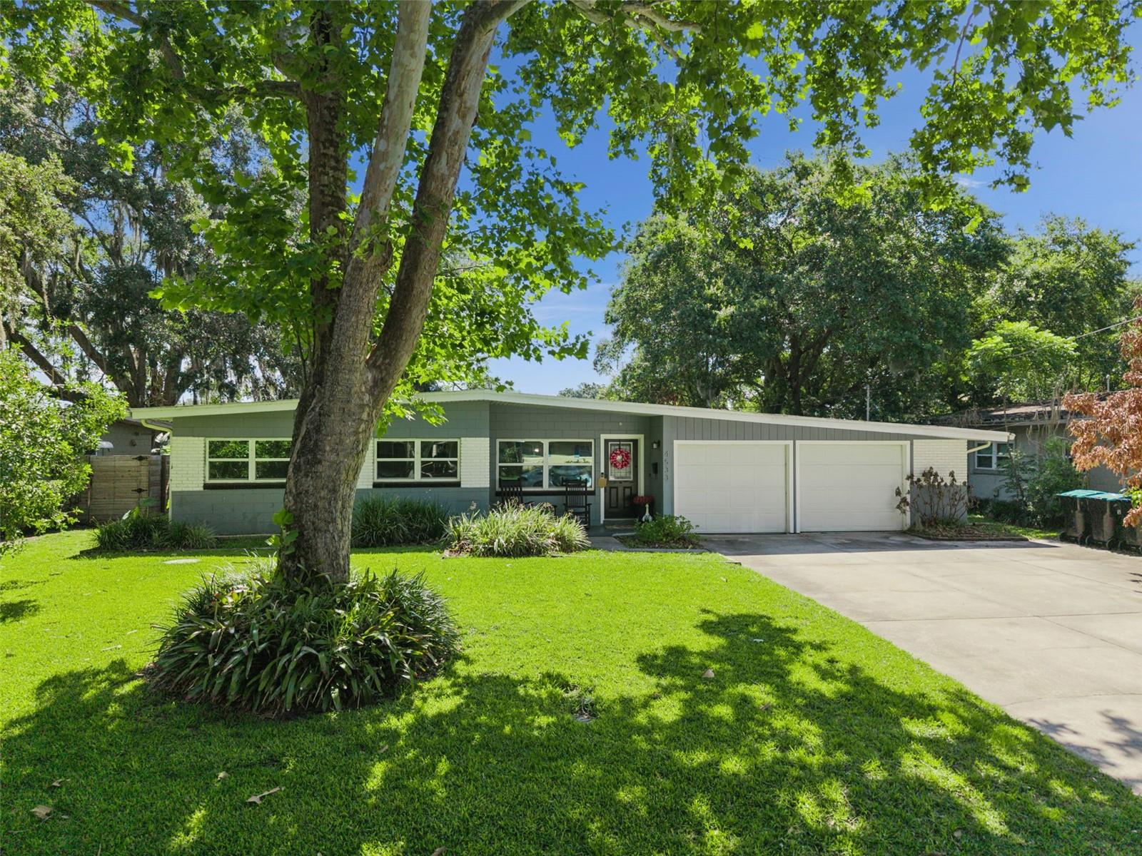 Tucked away on a quiet street in one of Conway’s most desirable neighborhoods, this lakefront home offers the perfect blend of calmness and convenience. Situated directly on Lake Inwood, one of the cleanest lakes in the area, the property’s timeless mid-century modern character is seen throughout, complemented by warm and inviting traditional touches. The kitchen features stone countertops, butcher block island, stainless steel appliances, a large sink and plenty of working space. Step down into the oversized family room - the heart of the home with a classic wood burning fireplace with its original, charming brick surround. Away from the other bedrooms, a generously sized spare room/office with large picture window overlooks the backyard and lake. On the back patio, a brand new covered, screened lanai invites you to enjoy the lakefront tranquility year-round, plus a fully fenced in yard. Don’t miss this rare opportunity to live on a quiet street with water views, while also being central to the airport, downtown, Orlando Health, Disney and the theme parks, major highways, and beautiful Lake Conway.