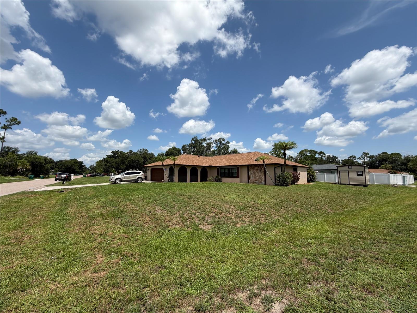 Don't miss this lovely 3 Bed, 2 Bath POOL home on a double lot (.55 acres).  Granite Countertops and Wood Cabinetry. Under Cabinet Lighting and Skylights. Wet Bar. Luxury Vinyl Plank Flooring Throughout.  Impact Windows. The recently upgraded primary bath has an Anti-fog LED Bathroom Mirror, Wood Cabinets, Stone Countertops and Dual Sinks, Beautiful Shower Tile and Glass Doors.  The Garage has Epoxy Flooring, Pull-down Attic, Pre-Wired for a Generator and Mini-Split A/C.  Separate Laundry Room with Wash Sink.  This Large home features a living room/dining room as well as a family room/nook area.... lots of possibilities here!   New Shed 2023, Electrical Panel 2023, Roof 2022, A/C 2021, Impact Windows 2019, 
Stunning In-Ground Pool with 3-D images and Surrounding Pavers.    This won't last.... make your appointment today!