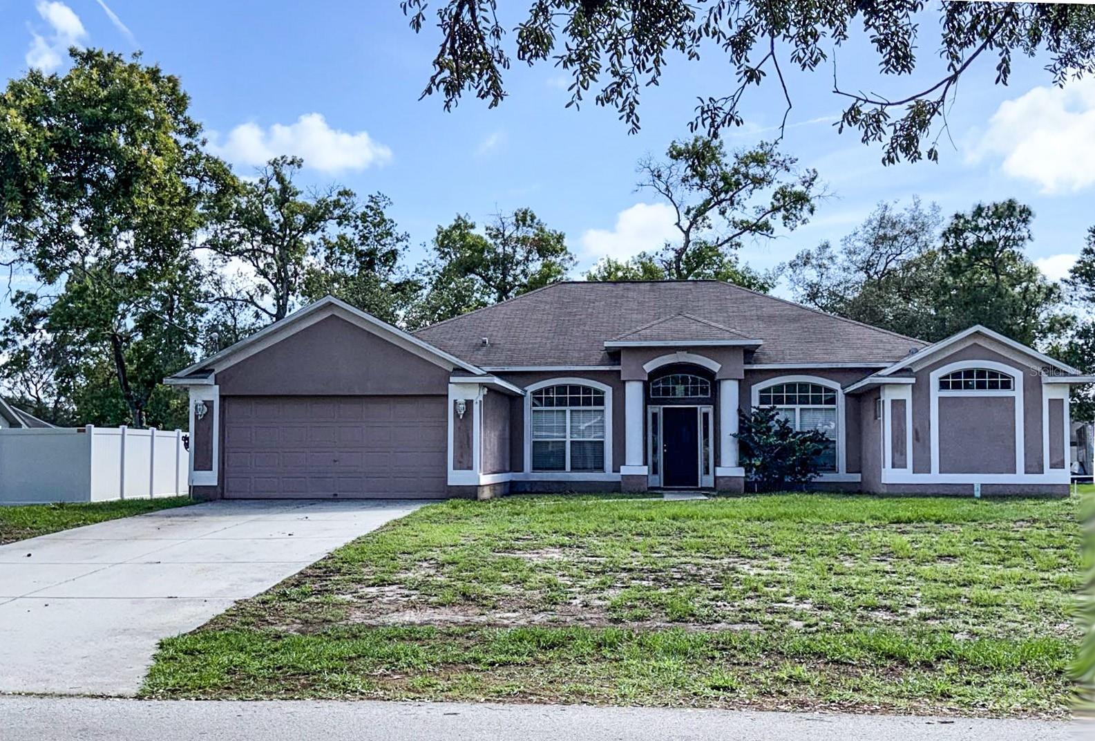 Welcome home to this inviting 4-bedroom, 2-bath residence on a spacious 1/3-acre lot in the heart of Spring Hill! Freshly painted inside and out with a newly installed A/C system, this move-in ready gem offers comfort and style from the moment you arrive.

Step into an expansive open-concept living and dining area that flows effortlessly into a generous kitchen perfect for entertaining. The kitchen boasts abundant granite counter space, plenty of cabinetry, an ample pantry, a convenient built-in desk nook, and a bright breakfast area overlooking the living space.

The oversized primary suite is a true retreat, complete with two walk-in closets and a luxurious en-suite bath featuring dual sinks, a walk-in shower, a deep garden tub, and a private water closet. The additional three bedrooms provide ample space for family, guests, or a home office.

Outside, relax on the fantastic covered patio that stretches nearly the full width of the home while enjoying your large front and backyard — ideal for barbecues, gardening, or entertaining.

Spring Hill delivers the best of Florida’s Nature Coast lifestyle with world-class amenities just minutes away. Enjoy the iconic Weeki Wachee Springs State Park with its mermaid shows and crystal-clear kayaking, beautiful Gulf beaches at Pine Island and Hernando Beach, miles of trails, and abundant parks and preserves. The neighborhood offers convenient shopping, dining, and everyday essentials, with easy access to the Suncoast Parkway for quick trips to Tampa.

This beautifully updated 2005-built home with tile and laminate flooring throughout, ceramic tile in the foyer, kitchen and baths, a 2-car garage, and a brand new A/C system perfectly blends comfortable living with the relaxed charm and outdoor opportunities of Spring Hill. Schedule your private showing today before this opportunity is gone!
