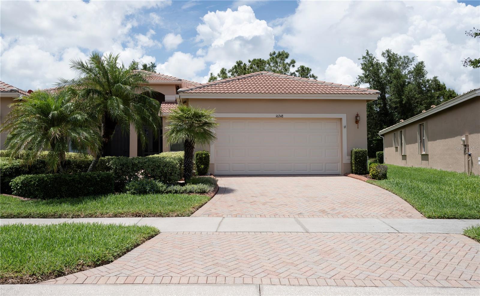 Welcome to the lifestyle you’ve earned in the award-winning 55+ resort community of Valencia Lakes — where every day feels like a vacation and neighbors quickly become lifelong friends. This stunning "Isabella" villa offers the perfect blend of luxury, comfort, and carefree living, all wrapped into one beautifully maintained, move-in-ready home.
         Inside, warm tile flooring flows throughout the open-concept layout, creating an inviting atmosphere ideal for both entertaining and everyday living. The heart of the home is the beautifully appointed kitchen, designed to impress even the most discerning chef. The adjoining dinette provides the perfect spot to enjoy morning coffee while planning the day’s activities, whether it’s pickleball with friends, a fitness class, or an evening social at the clubhouse.
       The spacious primary suite is your own private retreat, complete with a large walk-in closet, lighted ceiling fan, and a serene ensuite bath designed for relaxation after a fun-filled day in the community. Guests will feel equally pampered in the generously sized secondary bedroom with nearby private bath, offering comfort and privacy for visiting family and friends.
      Step outside to the tranquil lanai, where you can unwind with a good book, enjoy nature’s beauty, or toast another spectacular Florida sunset. 
      At the heart of Valencia Lakes is a spectacular 40,000-square-foot clubhouse that serves as the social hub of the community. Residents enjoy a vibrant calendar filled with dances, concerts, clubs, events, and endless opportunities to connect and stay active. Amenities include resort-style pools, lap and resistance pools, a state-of-the-art fitness center with instructor-led classes, pickleball and tennis courts, softball, basketball, bocce, shuffleboard, billiards, poker and card rooms, plus an impressive arts and crafts studio.
Whether you’re seeking an active social lifestyle, peaceful relaxation, or the perfect balance of both, this exceptional villa offers more than just a home — it offers a vibrant new chapter filled with friendships, activities, wellness, and the carefree Florida resort lifestyle you’ve been dreaming about.