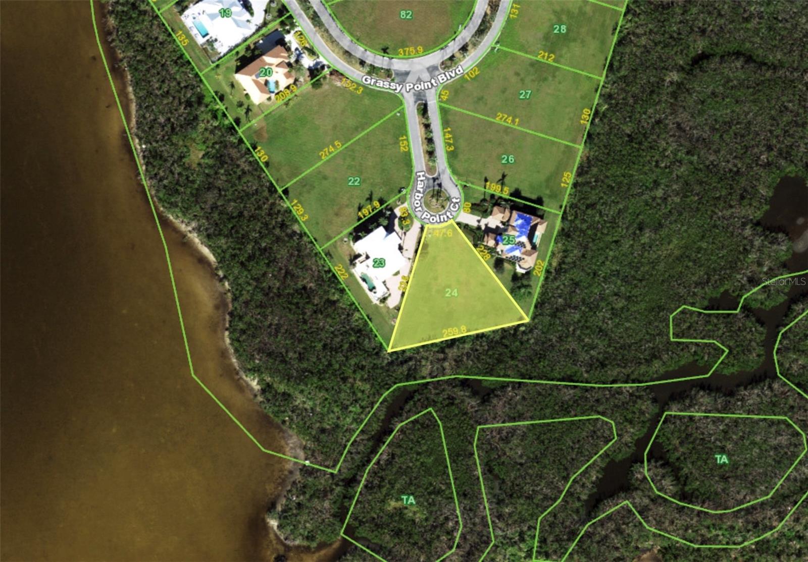 Grassy Point Estates almost 3/4 of an Acre Lot to build your new dream home in this Premier Gated Community. This most private setting is nestled in a neighborhood of stunning estate homes. "Spectacular Views" of Charlotte Harbor are possible from the 2nd and 3rd floor of your new dream home. Purchase includes assigned deeded boat slip B6, and is just down the street in Grassy Point's Beautiful, private deep water marina directly off the Charlotte Harbor. Located on a peninsula at the edge of Charlotte Harbor, Grassy Point offers the most luxurious beautiful landscaped waterfront property in the entire area! This wonderful neighborhood is situated around a private 6 acre Deep Water basin Marina with immediate deepwater access to Charlotte Harbor and on and out to the Gulf of America. Impeccably landscaped tree lined streets offer a appealing, safe and secure private community that is ideal for biking, walking and excellent boating. This community features 86 estate home sites, an Old Florida clubhouse and a private gated entrance with 24 hour manned security. Grassy Point is minutes from shopping, dining, medical care, waterfront parks and stunning historic downtown Punta Gorda with all it has to offer!