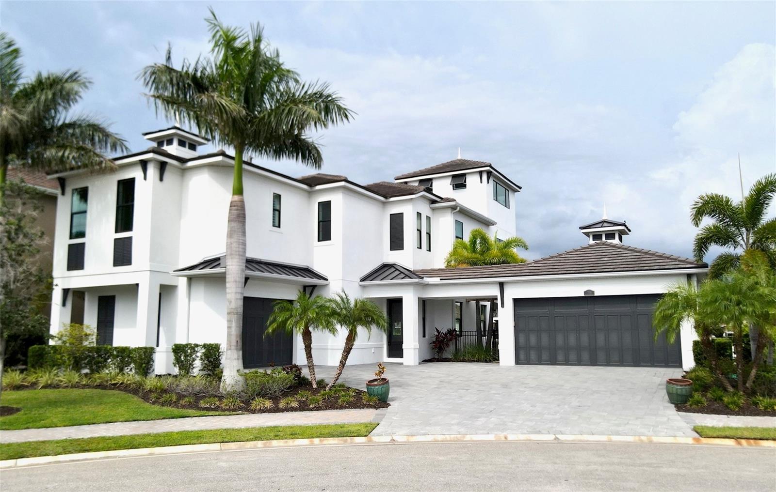 Welcome to a world of luxury in this stunning 3-story former model home. Located on a saltwater canal with direct access to the Manatee River, whether you’re an avid boater or simply appreciate the serenity of waterfront living, this home offers an unparalleled opportunity to embrace nature's beauty. The main floor features an open-concept layout, creating a seamless flow between the living, dining, and kitchen areas and offers a delightful setting for family meals or entertaining guests. Equipped with high-end appliances, ample counter space, and custom cabinetry, this gourmet kitchen is a haven for aspiring chefs and culinary enthusiasts. Step outside and be greeted by your outdoor paradise. You’ll find a perfect setting for savoring your morning coffee, relaxing in the warmth of the sun after a dip in the pool, enjoying al fresco dining with friends, or simply unwinding with a cool beverage at the end of a busy day. Back inside and up the stairs, you’ll discover the private living space that features a large family room, perfect for movie nights, as there’s a wet bar with a wine/beverage fridge and separate ice maker; a sun room/reading nook overlooks the canal; a storage closet at the top of the stairs plus another storage closet underneath the stairs that lead to the 3rd floor. The oversized laundry room is conveniently located near the bedrooms and includes a stacked washer/dryer set and an abundance of cabinetry and countertop space. Each bedroom is thoughtfully designed to provide a private oasis for relaxation and rejuvenation with a shared bath for the guest bedrooms. The owner’s suite offers panoramic views from the expansive bedroom windows and a luxurious ensuite bathroom featuring top-of-the-line fixtures and finishes…dual vanity sinks with marble-look quartz countertop; an oversized shower for 2 with dual shower heads and separate controls; plus a spacious walk-in closet with built-in closet system. Among the many unique architectural features of this home, one of the most impressive is the rooftop deck on the third-floor. Whether you're basking in the sun or mesmerized by the stars at night, this rooftop paradise is an enchanting escape. All of this, along with the opportunity to live in one of Southwest Florida's most sought-after boating communities, The Inlets! Nestled along the banks of the Manatee River, you have easy access by boat or by car to first-class restaurants and shopping, amazing golf courses, world-renowned beaches. Take a boat ride and enjoy an awe-inspiring sunset from the water...you're only 30 minutes from the Gulf of Mexico. And if you ever want to get away, there are 3 international airports within easy driving distance! But with tennis courts, kayak launch, walking trails and a park, in addition to this amazing home, why would you ever want to leave your own piece of paradise? Schedule your showing today and start living your Florida dream! Boat lift will accommodate up to 25,000# and has water and electric. Home is being sold As-Is with all furnishings included.