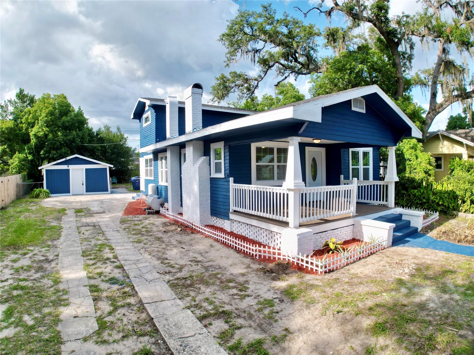 Beautifully refreshed and full of character, this stunning two-story home blends timeless charm with stylish modern finishes. From the striking navy exterior and expansive covered front porch to the detached garage and long driveway, this property makes a lasting first impression.

Step inside to discover approximately 1,500 square feet of thoughtfully designed living space featuring luxury vinyl flooring, recessed lighting, abundant natural light, and a spacious living room centered around a classic brick fireplace with custom built-ins.

The kitchen has been tastefully updated with shaker-style cabinetry, quartz countertops, stainless steel appliances, brushed gold fixtures, and ample cabinet and counter space. The bathrooms have been beautifully renovated with designer finishes, including a luxurious primary bath featuring a freestanding soaking tub, oversized walk-in shower, dual-sink vanity, and elegant tile work.

The spacious covered front porch is the perfect place to enjoy your morning coffee or unwind in the evening, while the detached garage offers additional storage, workshop potential, or parking flexibility.

Conveniently located near shopping, dining, parks, and major roadways, this move-in-ready home offers the perfect combination of classic character and modern style. Don’t miss your opportunity to own this beautifully updated home—schedule your private showing today!