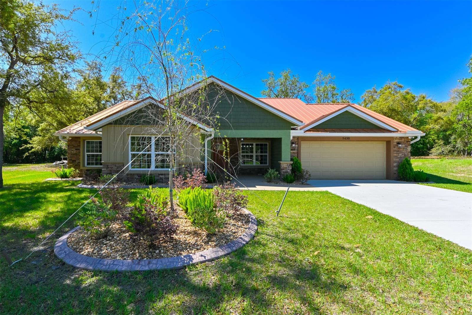 NEW CONSTRUCTION, A TRULY CUSTOM HOME UNSURPASSED IN CRAFTSMANSHIP AND FEATURES. Highlights include a stunning copper coloured metal roof ($45K), a large, paved, screened-in lanai with a rectangular propane fire pit ($120K) and an elegant stone retaining wall ($50K) joined by a wooden fence enclosing the back yard for maximum privacy. This custom home is offered by a longtime area builder and no expense was spared in its creation! Built for longevity, low maintenance and energy efficiency, you will not find another home in its class at this price point. 3 BR/2 bath/2 car garage. Open plan. Volume ceilings. Upscale kitchen appliances. Breakfast bar. Separate dining area. Tray ceilings in each BR. Stone countertops throughout. Custom lighting. Custom cabinetry. Epoxied floor in the garage. Custom built closet encloses the HVAC unit. Dedicated laundry closet. TESLA charger in garage. Plumbed for outdoor gas grill. Primary bedroom features dual closets, dual bathroom vanities and custom tile in the large walk in shower. Low HOA is $125/mth. Genuinely superior construction overall. Great attention to detail and design features. Community pool and clubhouse are in the planning process with no definite finish dates. The Stonegate community is highly unique and strategically located! Upgraded and custom features are part of every home package with a strong focus on energy efficiency, longevity and overall low maintenance. A Standard Features list is available upon request. Stonegate is very convenient to the recently completed extension of the Suncoast Highway making the overall location convenient to Tampa, Tampa International airport & environs. Citrus county is well known for its pristine waters and famous springs. The actual date of construction is 2024 with COO issued in 2024. Move in ready, never occupied. This home is offered for sale only, please no rental requests. Builder states no offers site unseen. Buyer to verify taxes with county. This property is BRAND NEW and has significant upgrades that are unique to the community.