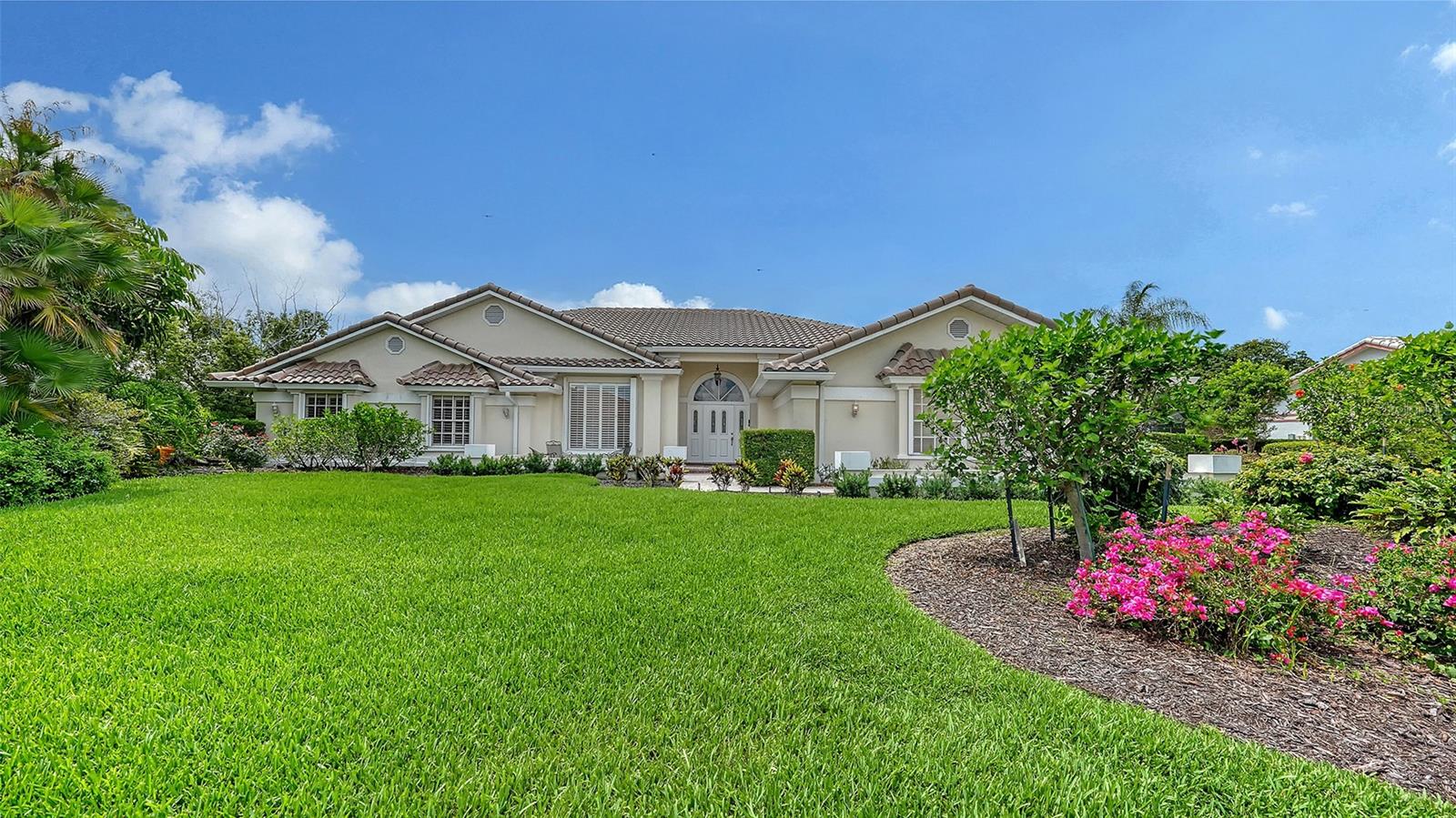 Nestled behind the gates of one of Sarasota’s most established neighborhoods, this Prestancia home offers quiet luxury and golf course views, where expansive indoor and outdoor living spaces epitomize Florida-living. The thoughtfully designed layout boasts a private master wing on one side, and casual living areas and additional bedrooms on the opposite. Joining the two wings are a formal dining and living room, distinguished by high ceilings, transom windows, and sliding doors which lead to an inviting outdoor retreat. The grand, master suite includes a dressing area, large walk-in closets, and a convenient, wall-enclosed dog yard for pets to safely enjoy. The adjoining master bath hosts separate custom vanities, a Roman walk-in shower, and a water-closet equipped with a hands-free electronic toilet/bidet. Just beyond the spa tub, double French doors open onto a secluded outdoor gathering space complete with a fireplace, perfect for unwinding on cozy evenings. The spacious kitchen is well suited for preparing both gourmet meals and quick refreshments served through the pass-through sliding windows that open to the outdoor eating area. Adjacent the kitchen is a large family room with soaring ceilings, a stone fireplace, and full wet bar. The outdoor oasis is bordered by the home on three sides and the 3rd hole of TPC Prestancia on the fourth, and includes a sparkling pool and spa, integrated grill, shaded area for dining and plenty of space to enjoy Florida sunshine. Residents of this Audubon Cooperative Sanctuary community enjoy watching families of sandhill cranes while bald eagles soar overhead. Just minutes from Siesta Key Beach and downtown Sarasota, the home’s new roof, pull down storm shutters, and a whole home generator provide worry-free living. Optional membership is available at TPC Prestancia Golf Club featuring two 18-hole courses, dining, and social activities.