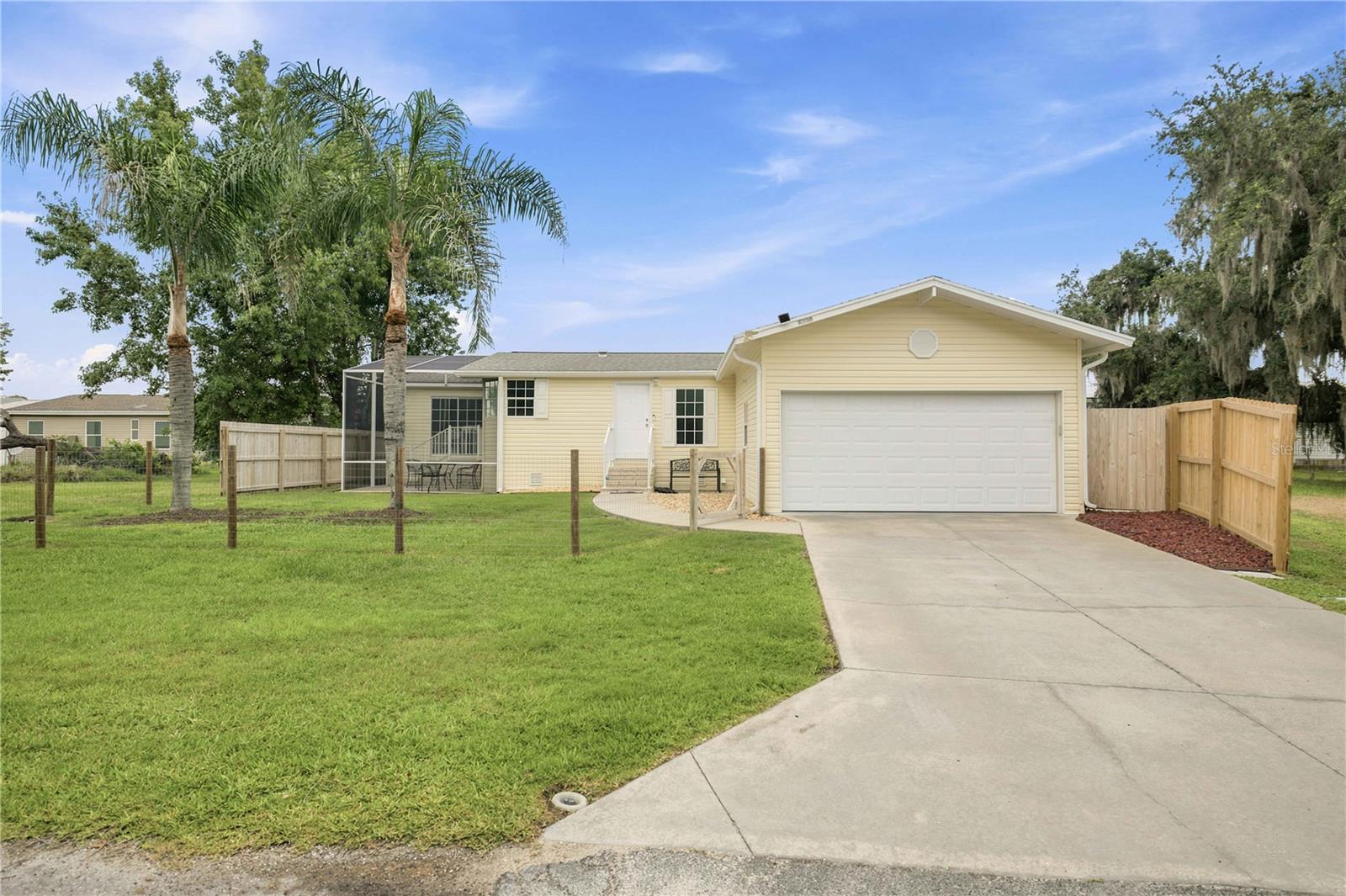 LOCATION, LOCATION, LOCATION! This spotless, move-in ready 2-bedroom, 2-bath home offers the perfect blend of comfort, style, and convenience. Inside, you’ll find luxury vinyl plank flooring throughout, a spacious eat-in kitchen with ample cabinet and counter space, a convenient inside laundry room, and a large primary suite featuring a beautifully updated walk-in tiled shower. Major updates include a new roof (2020), A/C with all-new ductwork (2020), KitchenAid dishwasher (2023), garbage disposal (2023), plus a 2-car garage, sprinkler system, rain gutters, and a screened birdcage lanai—perfect for relaxing or entertaining. Nestled in a quiet, golf-cart-friendly community with low HOA fees and underground utilities, you’ll enjoy an unbeatable lifestyle just outside The Villages. Located just minutes from Brownwood Paddock Square, you’ll have easy access to nightly live entertainment, outstanding restaurants, boutique shopping, and everyday conveniences. Medical offices and an emergency room are only 5 minutes away, while Buena Vista Boulevard, State Road 44, I-75, and Florida’s Turnpike are all easily accessible, making travel throughout Central Florida effortless. Whether you’re looking for a full-time residence or a seasonal Florida retreat, this beautifully maintained home offers modern updates, meticulous care, and an exceptional location. Don’t miss your opportunity to make it yours!