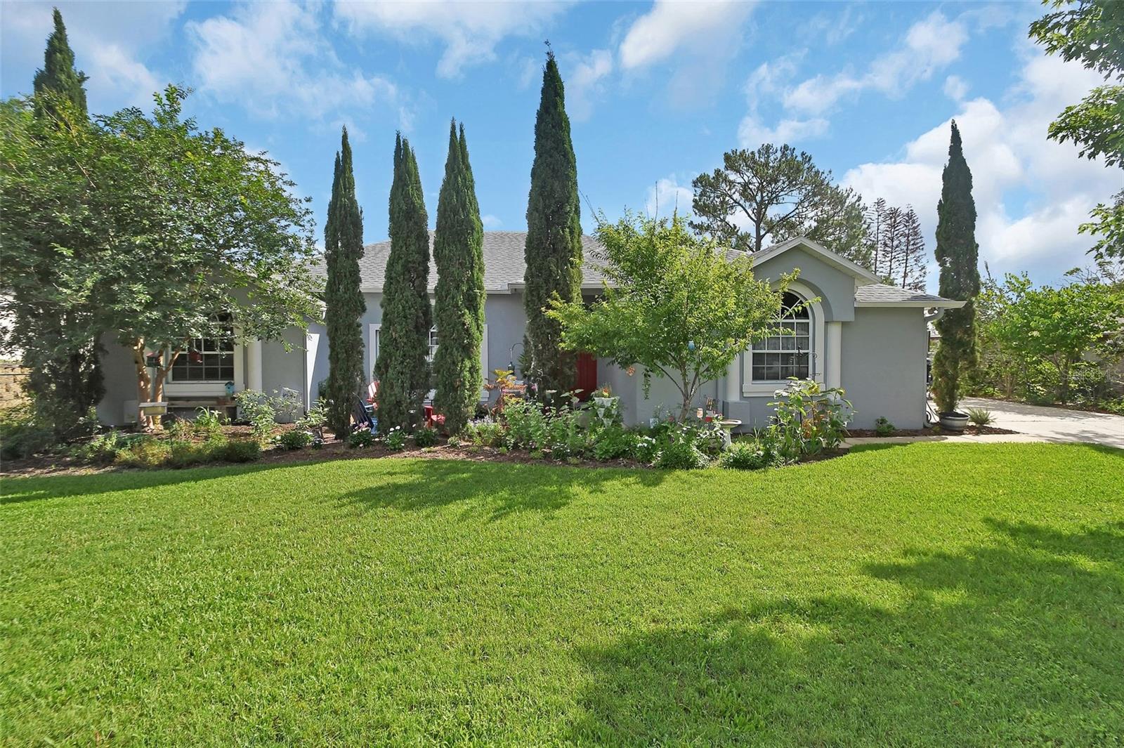 LAKEFRONT-POOL Home in Deltona, Picture perfect piece of paradise and NO HOA, so bring your RV. .034 acre lot. with 100 feet of Lake front property.
Wake up to breathtaking sunrises and unwind with stunning sunsets from your private patio and enclosed pool area overlooking the lake. This beautifully maintained all-block home offers 4 bedrooms, 2 bathrooms, and a spacious floor plan designed for comfort, flexibility, and everyday living.
The home features a living room and formal dining room, while the kitchen serves as the heart of the home, perfectly positioned with picturesque views of the pool and lake. The adjoining great room and dinette area provide additional gathering space, making this layout ideal for multigenerational living, entertaining, or hosting family and guests. The warmth of the fireplace adds to the inviting atmosphere.
The spacious owner’s suite offers beautiful lake views and private access to the pool patio through its own set of French doors. The updated en-suite bathroom features dual vanities, a walk-in shower, and a beautifully tiled garden tub area designed for relaxation.
You will appreciate the oversized laundry and utility room, providing extra storage and functionality. Step outside through two separate sets of French doors to a fully fenced backyard complete with a garden area for those who enjoy growing their own vegetables. Lush landscaping surrounds the home, with installed jelly light around the exterior of home creating a peaceful, private setting that feels like your own personal retreat.
Additional features include a Tesla car charger already installed for added convenience.
If you have been dreaming of lakefront living with a pool, room to spread out, and beautiful outdoor surroundings, this Deltona gem is ready to welcome you home!
ROOF 2017, WATER HEATER 2015, AC SYSTEM 2015, SEPTIC SERVICED 2024. The garage actually have vents for AC should you want to create a workshop area.