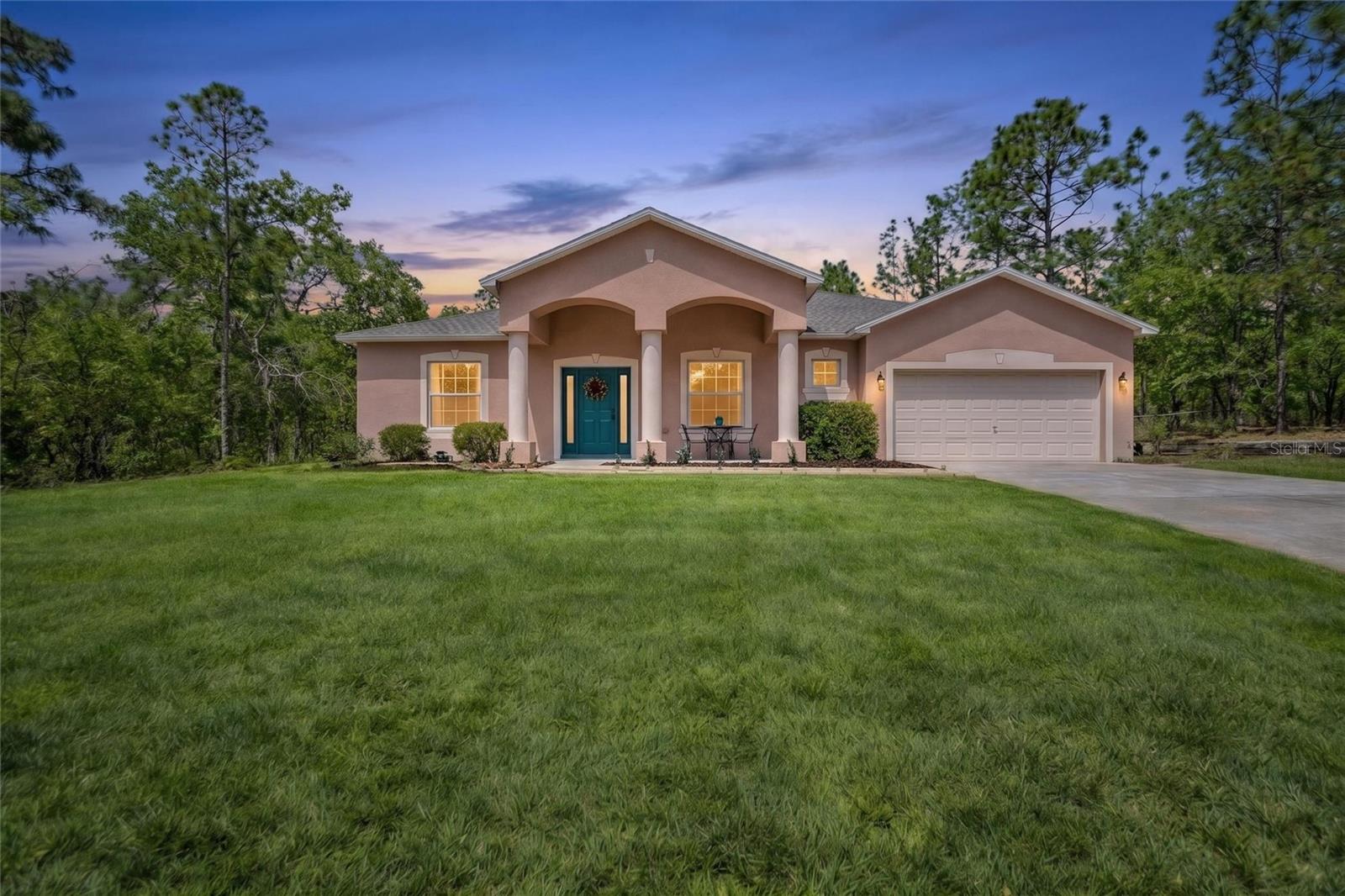 One or more photo(s) has been virtually staged. Citrus Springs pool home with 4 bedrooms, 3 full baths, 2 car garage plus bonus room. The custom chef’s kitchen features stainless steel appliances including a gas stove, expansive center island with black composite sink, a plethora of cabinet and counter space all open to the spacious family room overlooking the peaceful pool area. The spacious primary bedroom is separate from the 3 guest bedrooms offering extra privacy and serenity to enjoy the en-suite bath’s separate shower and garden soaking tub. The open foyer welcomes you with the formal dining room and bonus room (that could be used as a fifth bedroom, office, por den). The first guest bedroom is set in an alcove with easy access to the first guest bathroom. The other guest bedrooms are closer to the back of the home and pool bath with easy access to the screened in lanai. The peaceful backyard setting is perfect to relax in the pool with the sound of the wind through the pine trees and fireflies at dusk. There is a small fence for furry friends and no surrounding neighbors adding to the park-like ambiance. Home warranty provided and updates include new roof 2025, new septic tank 2026, new pool pump 2025, new hot water tank 2025, new carpet 2026, and luxury vinyl flooring 2026. The Florida lifestyle is complete living in this home among Citrus county’s famous natural wonders.