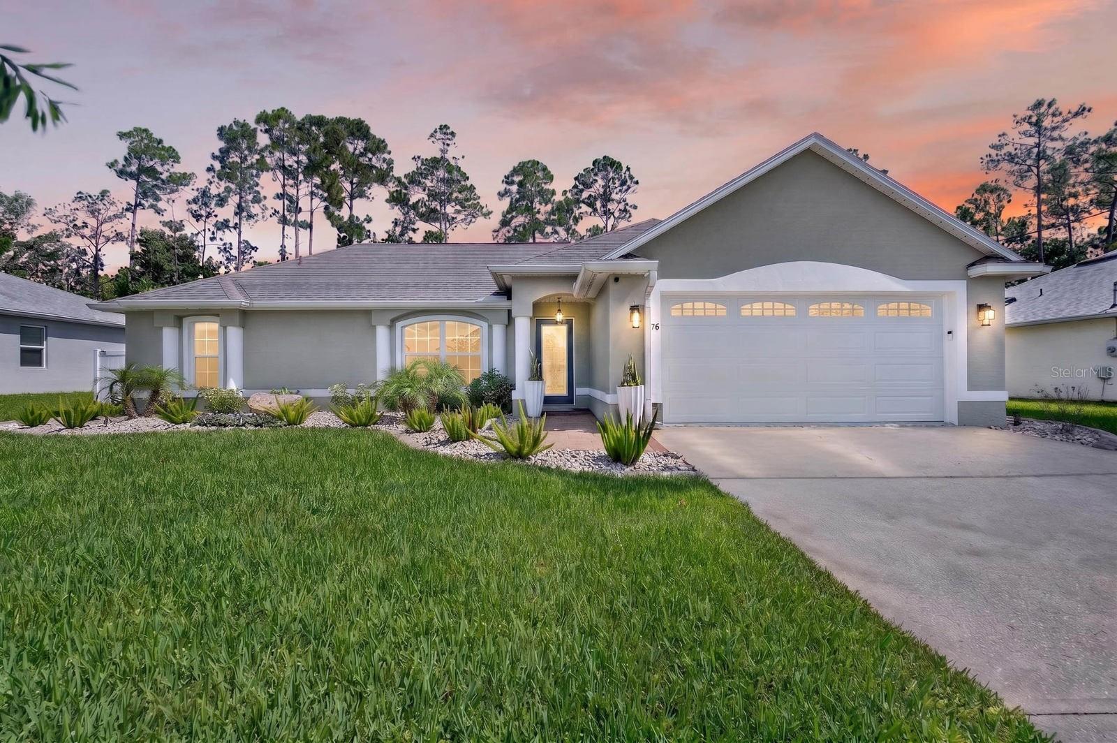 Imagine ending every day with a sunset swim, dinner from your outdoor kitchen, and peaceful waterfront views from your own backyard. Welcome to one of Palm Coast's most beautifully renovated freshwater canal pool homes. Located in desirable Pine Lakes community. 
From the moment you arrive, the attention to detail is undeniable. Fresh landscaping accented with landscape lighting, decorative concrete curbing, mature plantings, a striking new fiberglass front entry door, designer exterior lighting, and permanent app-controlled Gem Lights create exceptional curb appeal both day and night.
Inside, nearly every space has been thoughtfully transformed. The bright, open floor plan showcases designer lighting throughout, crown molding, custom blinds, upgraded ceiling fans, custom closet systems, and a stunning feature wall complete with an electric fireplace and ambient accent lighting that serves as the focal point of the living room.
The beautifully renovated kitchen blends style with functionality, featuring gorgeous quartz countertops, custom painted cabinetry with updated hardware, designer tile backsplash, new sink and faucet, and a full suite of GE Profile stainless appliances including an Air Fry/Convection range.  The owner's suite offers a peaceful retreat with a custom-designed walk-in closet and a beautifully refreshed ensuite featuring quartz countertops, updated fixtures, decorative wall treatments, and refined finishes. The guest bathroom has been completely reimagined with a luxurious soaking tub, custom glass enclosure, updated vanity, fixtures, lighting, and designer details.
Step outside and discover what truly sets this property apart.
The expansive screened lanai becomes a true extension of the home's living space, creating an incredible setting for entertaining or everyday relaxation. The resurfaced pool sparkles alongside a beautifully refinished pool deck, while the brand-new outdoor kitchen featuring a premium Coyote grill, Monte Alpi refrigerator, and generous storage makes outdoor dining effortless. Whether hosting family gatherings, watching football by the pool, or enjoying a quiet evening under the stars, this backyard was designed to be lived in.
Beyond the pool, a newly installed aluminum fence frames the peaceful freshwater canal while preserving the beautiful water views. Direct access to the canal provides the opportunity to add your own private dock, opening the door to kayaking, fishing right from your backyard.
Equally impressive are the countless behind-the-scenes improvements that add long-term value and convenience, including a new variable-speed Jandy pool pump, water softener, Ecobee smart thermostat, Blink security system with doorbell and exterior cameras, insulated garage door with windows, smart garage door opener, polyaspartic-coated garage floor, resurfaced lanai, upgraded laundry room, and numerous smart-home features designed for today's lifestyle.
Located just minutes from Flagler Beach, shopping, dining, parks, golf courses, medical facilities, and Interstate 95, residents enjoy easy access to historic St. Augustine, Daytona Beach, and all that Palm Coast has become known for including more than 130 miles of scenic walking and biking trails and more. Beautifully renovated, meticulously maintained, and thoughtfully upgraded from top to bottom, this is far more than a home, it is a lifestyle.