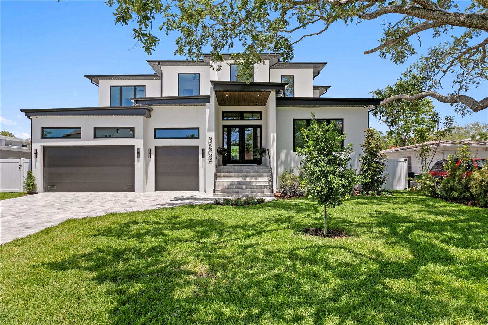 Experience refined living in this brand-new executive pool home, perfectly situated within the coveted A+ school zone for Mabry, Coleman, and Plant. Designed with a modern aesthetic and built for everyday luxury, this 4,812 sq. ft. residence offers 5 bedrooms, 5.5 bathrooms, a private study, second floor loft and 3 car garage—all on an oversized 73x120 lot. Inside, the open-concept design centers around a grand living area anchored by a 7-foot linear fireplace. The chef’s kitchen is a true showpiece, featuring custom wood cabinetry, waterfall-edge quartz island and backsplash, and top-tier SubZero and Wolf appliances. A walk-in pantry butler’s pantry complete with work sink and mudroom provide thoughtful functionality for modern living. Throughout the home, designer lighting, premium fixtures, and 7.5” European white oak flooring create a seamless, sophisticated atmosphere, while porcelain and marble accents enhance the spa-like baths. Upstairs, the expansive primary suite offers a private sanctuary with custom walk-in closets and a spa-inspired bath featuring dual vanity along with direct access to laundry room, a freestanding soaking tub, and a frameless glass shower. Four additional bedrooms and baths complete the second floor along with a bonus loft space. Step outside to your private backyard oasis—complete with a resort-style pool, lush green space, and room to entertain or unwind. Built elevated to exceed FEMA standards, this home offers lasting confidence and comfort. Built with block construction and Low-E impact windows and doors, this home pairs exceptional craftsmanship with peace of mind. Paver finishes grace the driveway, patio, and porches for a clean, timeless curb appeal. Discover luxury living at its finest—schedule your private showing today.