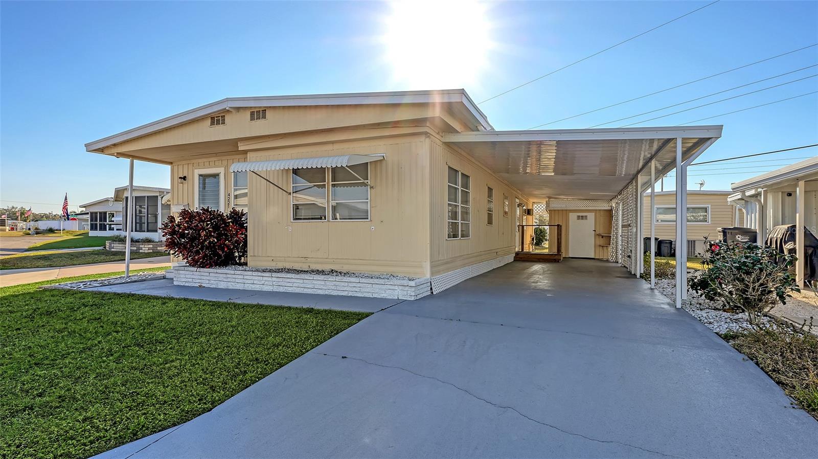 Welcome to easy Florida living in this sought-after 55+ community where you own both the home and the land—no lot rent! This well-maintained 2-bedroom, 1-bath home features a double-length carport, attached workshop/storage shed, and plenty of outdoor space to enjoy. Residents enjoy an active lifestyle with a busy social calendar including dances, card games, golf groups, social clubs, pickleball, shuffleboard, basketball, and a heated community pool. Conveniently located just minutes from the Ellenton Outlets, shopping, dining, and I-75, offering easy access to Sarasota, St. Petersburg, and Tampa. Don’t miss this opportunity to own an affordable home in a vibrant, amenity-rich community!