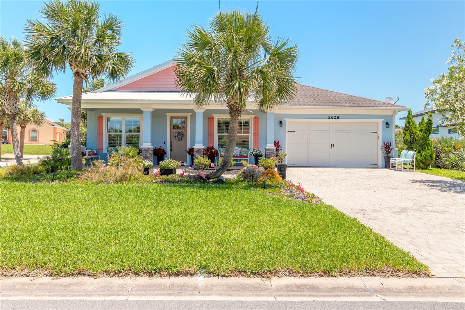 Experience coastal luxury living in this spectacular custom-built 2014 Key West style pool home perfectly situated between the Atlantic Ocean and the Intracoastal Waterway in the heart of beautiful Flagler Beach. From the moment you arrive, you’ll be captivated by the exceptional curb appeal featuring lush tropical landscaping, a stone-paver driveway, and welcoming front walkway that set the tone for the elegance found throughout the home. Designed with both comfort and entertaining in mind, this impressive 4-bedroom, 2-bath residence showcases quality craftsmanship and upgrades at every turn. Step inside to discover soaring 10-foot tray ceilings, crown molding, decorative columns, custom 7¼-inch baseboards, recessed lighting, upgraded fixtures and fans, along with a sophisticated blend of tile flooring and carpeting. The spacious open-concept floor plan seamlessly connects the living, dining, and family rooms, creating the perfect gathering space for family and friends. A stunning stone fireplace serves as the focal point of the family room, adding warmth and charm to the home’s inviting atmosphere. The chef-inspired kitchen is a true showpiece featuring custom 42-inch white cabinetry with under-cabinet lighting, granite countertops, tiled backsplash, stainless steel appliances, and abundant storage and prep space. Retreat to the luxurious owner’s suite where you can unwind in your spa-like bath complete with a relaxing Jacuzzi tub, walk-in tiled shower, double sink vanity, and spacious walk-in closet. Sliding glass doors lead to an oversized screened lanai designed for year-round outdoor living and entertaining, complete with a summer kitchen ideal for hosting gatherings or simply enjoying the coastal breeze. Outside, enjoy your private saltwater pool, which can be heated during the cooler seasons, allowing for year-round relaxation and enjoyment. This home truly offers the ultimate Florida lifestyle, just minutes from the beach, Intracoastal activities, dining, shopping, and everything Flagler Beach has to offer. Own your own piece of paradise in one of Florida’s most desirable coastal communities. All furnishings can be negotiated with sale. All information deemed accurate but cannot be guaranteed. Roof 2014, AC 3 years old and hot water heater is original.