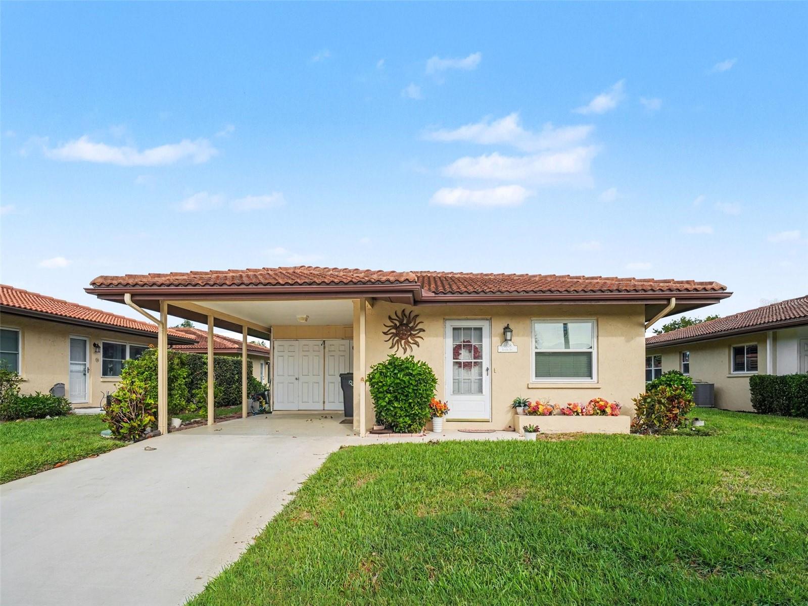 One or more photo(s) has been virtually staged. Welcome to the highly desirable 55+ community of Cambridge Village! This beautifully maintained 2-bedroom, 2-bathroom home offers comfort, convenience, and a relaxed Florida lifestyle. Enjoy peace of mind with new windows and doors installed in 2018. The bright, inviting kitchen provides ample storage, while the thoughtfully designed split-bedroom layout ensures privacy for both residents and guests. The spacious primary suite features a walk-in closet and a private en-suite bath. Unwind in the Florida room or step outside to your private patio—perfect for morning coffee or entertaining friends. Out back, enjoy serene water views where you can often spot birds and ducks, creating a peaceful, nature-filled setting right in your own backyard. With HOA-covered lawn care, you’ll enjoy truly low-maintenance living. Cambridge Village also offers a vibrant lifestyle with amenities including a clubhouse, heated pool, shuffleboard courts, and a full calendar of social events. Don’t miss this opportunity to enjoy easy living in a welcoming, active community!