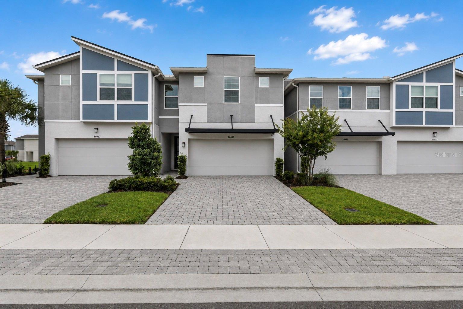 Welcome to this beautifully almost NEW 4-bedroom, 3-bathroom 2 car garage townhome offering 2,574 square feet of thoughtfully designed living space in the highly desirable Volanti community of Lutz/Wesley Chapel. NO CDD LOW HOA. Gated community with 24 surveillance This move-in-ready home features an open-concept floor plan that seamlessly blends the kitchen, dining, and living areas, creating the perfect space for everyday living and entertaining. The bright and spacious kitchen is complete with white cabinetry, quartz countertops, a large center island with seating, stainless steel appliances, a brand-new dishwasher, abundant cabinet space, and a generous walk-in pantry. The main living area opens to 8-foot sliding doors onto a covered lanai overlooking peaceful pond views, providing the perfect place to relax and enjoy Florida living. One additional bedroom and bathroom are on the main floor. Upstairs, you'll find a versatile loft that can serve as a second living area, media room, playroom, or home office. The spacious primary suite offers a large walk-in closet and an ensuite bath with dual vanities and a walk-in shower. Two additional bedrooms and a full bathroom provide plenty of room for family, guests, or flexible work-from-home space. Additional features include a two-car garage equipped with an EV charging outlet for electric vehicles, tile flooring throughout the main living areas, neutral finishes, and plenty of storage throughout. inviting guest is a breeze with over 40 parking spots to accommodate friends and family. Conveniently located near premier shopping, dining, entertainment, medical facilities, and major highways, this home offers the perfect balance of comfort, convenience, and modern living. With its spacious layout, thoughtful upgrades, and sought-after location, this exceptional home is ready for its next owner. Schedule your private showing today. Welcome Home!