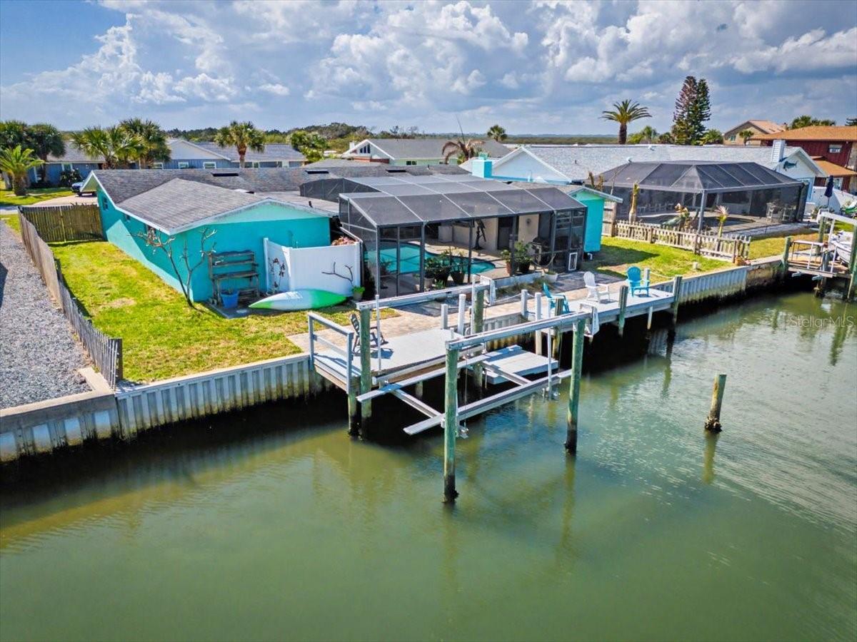 Welcome to your waterfront retreat in the sought-after Yacht Haven community of Ponce Inlet! Perfectly positioned on a quiet cul-de-sac, this 3-bedroom, 2-bath home offers 1,900+ square feet of comfortable coastal living with direct canal frontage and access to the Intracoastal Waterway. Step inside to find a spacious, light-filled layout featuring luxury vinyl, wood, and tile flooring, a cozy wood-burning fireplace, and multiple living areas including a family room and dedicated office space. The kitchen flows seamlessly into the dining and living areas—ideal for both everyday living and entertaining. Outdoors, enjoy true Florida living with a private screened-in pool, expansive deck, and your own dock complete with electric and lift—perfect for boating enthusiasts. Take advantage of easy access to the Halifax River, nearby marinas, and the beach just moments away. Additional highlights include a 2-car garage, central HVAC, stone countertops, walk-in closets, and a generously sized lot with private yard space. This home is fully handicap and wheelchair accessible. The primary bathroom has been beautifully remodeled with full wheelchair accessibility. Whether you're looking for a full-time residence or a coastal getaway, this home offers the best of waterfront living in one of Ponce Inlet’s most desirable locations.