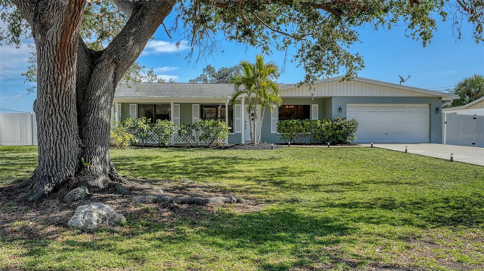 Perfectly positioned along the Barnes Parkway inlet on scenic Curry Creek, this waterfront property delivers the kind of direct Gulf-access boating lifestyle that has become increasingly rare along Florida’s Gulf Coast. From your private dock, cruise beneath the Legacy Trail and U.S. Route 41 and you’re immediately out into Roberts Bay, with the South Jetty Park opening directly to the Gulf beyond—with no additional bridges after US-41. Framed by tranquil mangroves, glowing sunset views, and tucked along a quiet dead-end street, the setting offers both privacy and effortless access to some of Southwest Florida’s best boating waters.

Set at an impressive 11-foot baseline elevation, the property offers rare peace of mind while maintaining true ownership flexibility with no HOA, no deed restrictions, and no CDD fees. Major system improvements provide additional confidence for buyers and include a new water heater (January 2026), septic drainfield (2022), HVAC system (2022), reverse osmosis water filtration at the kitchen sink and new garbage disposal (2025), complete cast-iron plumbing replacement under the slab (2016), updated electrical (2013), and a 30-year roof replacement (2013). Beaches, dining, parks, and golf are all just minutes away.

Offered TURNKEY FURNISHED AS SEEN (with a few small exclusions), the nearly 1,950-square-foot interior blends timeless mid-century character with thoughtful modern updates. Polished terrazzo floors, expansive windows, and an open, light-filled layout create an inviting atmosphere throughout. The waterfront-view lanai naturally extends the living area, while a covered front porch provides a peaceful place to enjoy sunrises and local birdlife.

The bright galley kitchen overlooks the canal and features granite countertops, tile backsplash, painted wood cabinetry, matte black hardware, stainless appliances, a walk-in pantry, built-in USB outlets, and smart storage.

The primary suite offers a walk-in closet and updated en-suite bath, while two additional guest bedrooms and a second updated bath provide comfortable accommodations for family and guests.

Situated on an almost one-third-acre fully fenced lot, the backyard offers exceptional space and flexibility rarely found on waterfront parcels—perfect for adding a pool, expanding outdoor entertaining areas, or creating a custom waterfront retreat. The 4' x 20' dock with water and electric accommodates boats up to approximately 25 feet, provides about five feet of clearance at high tide, and has lift potential. Mangrove-lined views enhance privacy without obstructing the water view, and a kayak launch sits conveniently across the street—making spontaneous paddles along Curry Creek part of everyday life.

KAYAK LAUNCH is directly across the street and to the left through the mangroves! Easy, quick and close!

A survey and elevation certificate (2015) are attached in the MLS. All fencing is owned except the shared south fence.

READY to Airbnb since it is sold furnished. READY to use a second home. READY to enjoy an average 254 days of Florida sunshine and the waterfront lifestyle with this property!

Opportunities combining water frontage with Gulf access, fenced in privacy, flexibility for leasing ROI, and generous waterfront land this is becoming increasingly harder to find.